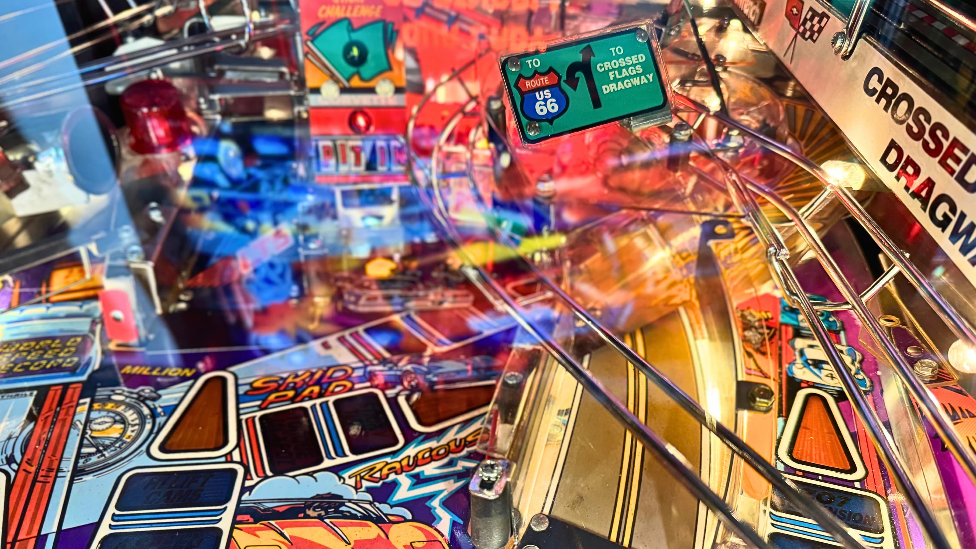 Colorful pinball machine with Route 66 and road signs, vibrant gameplay details