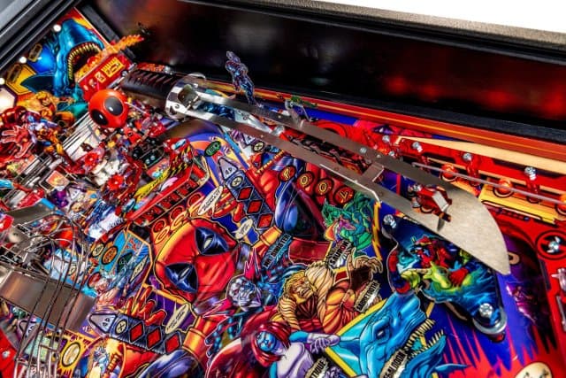 Colorful, detailed pinball machine playfield with vibrant characters and mechanical elements