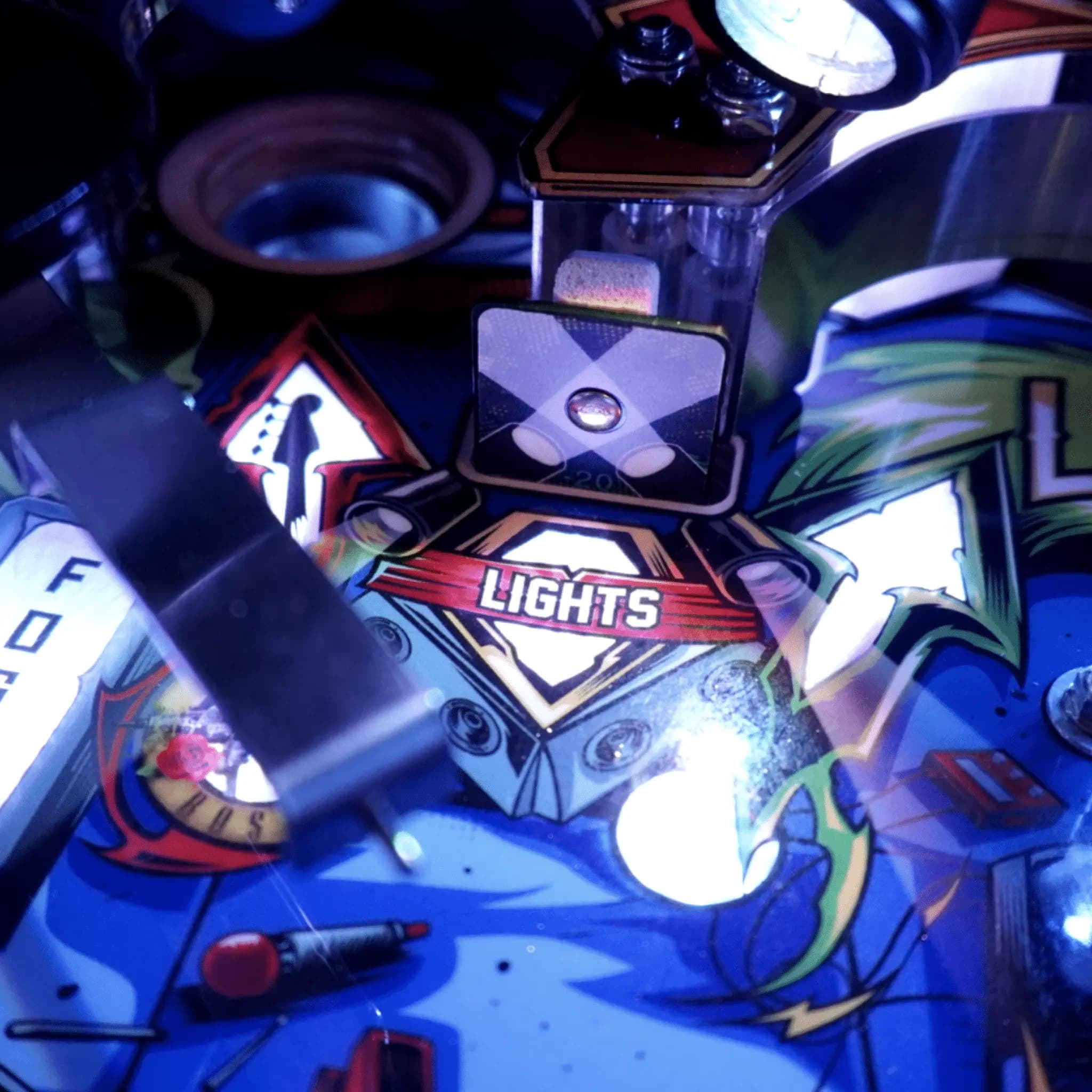 Pinball machine close-up with vibrant blue lights and 'Lights' logo