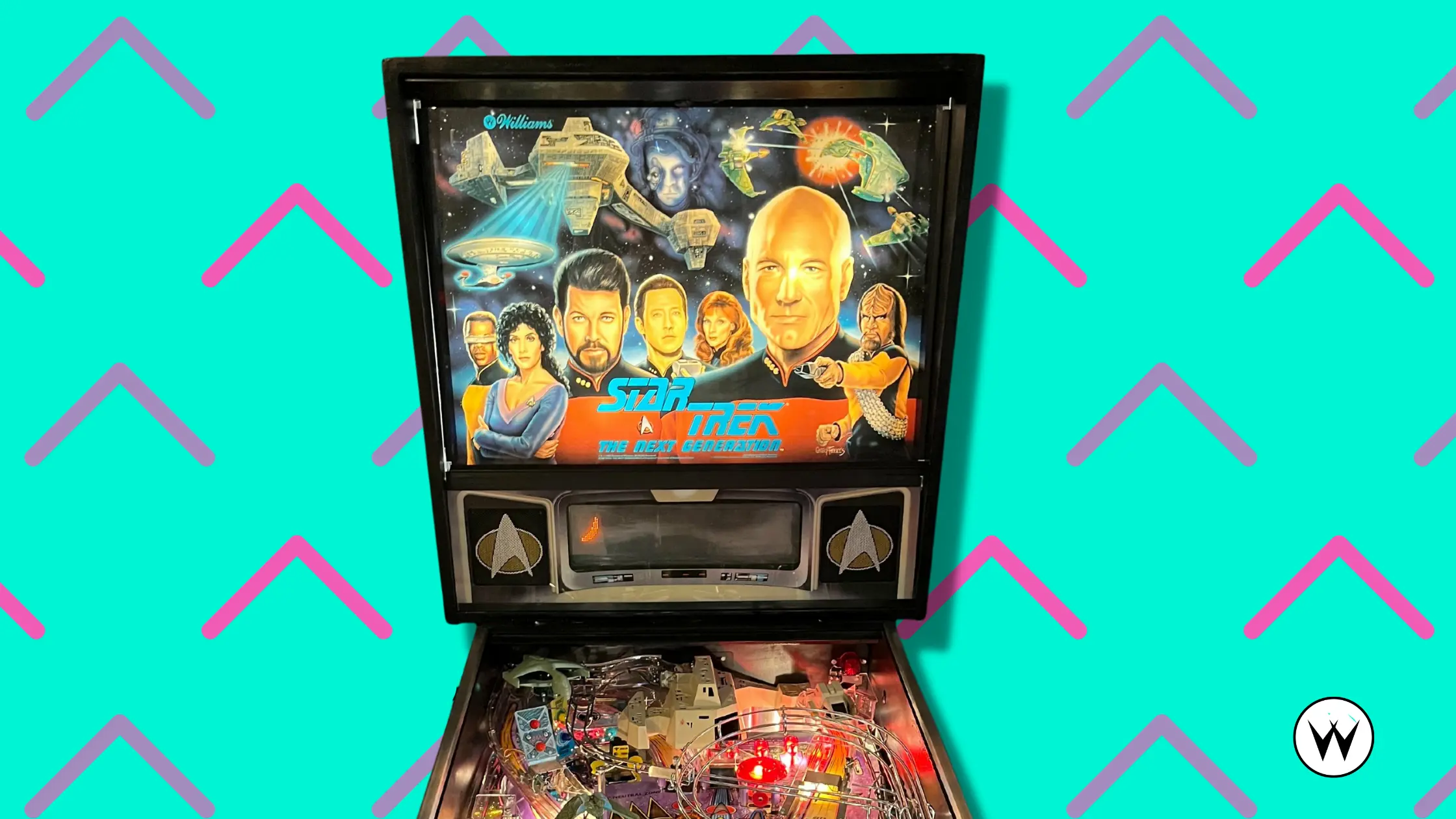 Star Trek: The Next Generation pinball machine with characters and spaceships