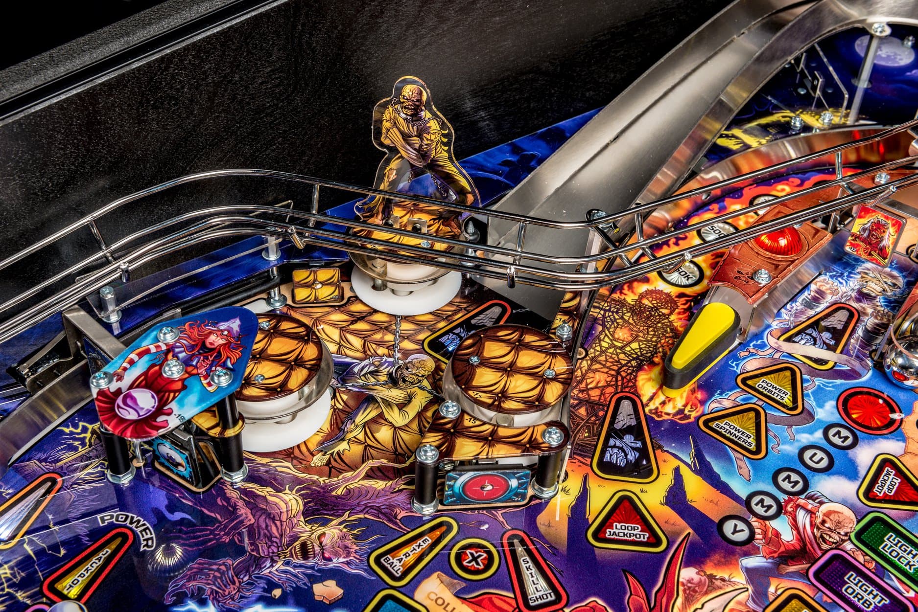 Colorful pinball machine with metallic ramps and golden zombie character
