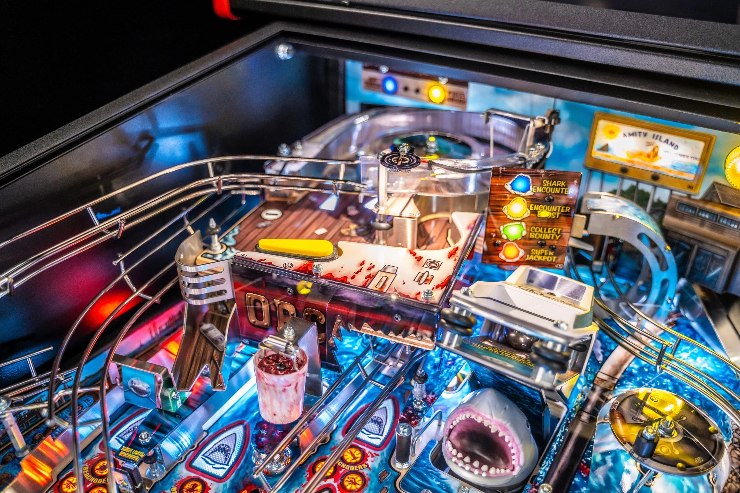 Detailed Jaws-themed pinball machine with shark, blood, and colorful gameplay elements