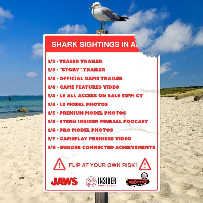 Seagull perched on Jaws movie promotional sign at sandy beach