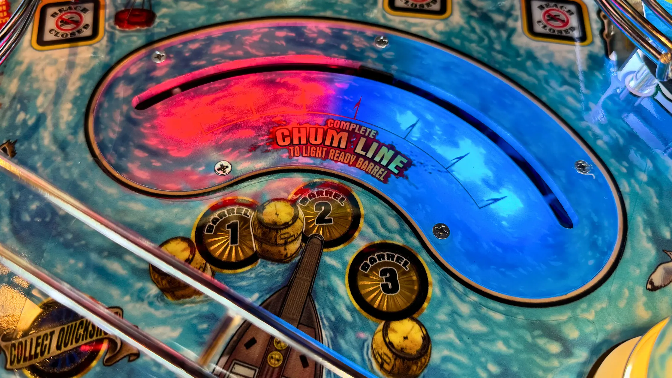 Pinball machine closeup with Chum Line barrel targets and colorful design