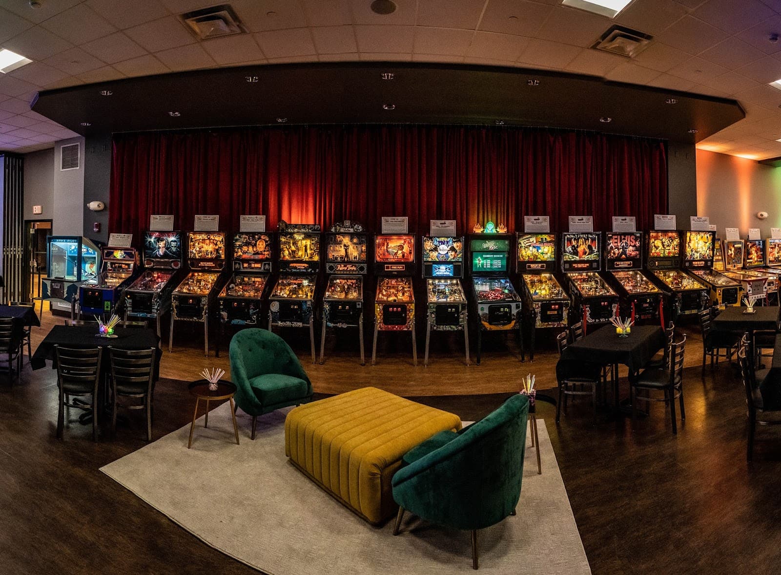 Vintage pinball machines lined up in a dimly lit arcade room