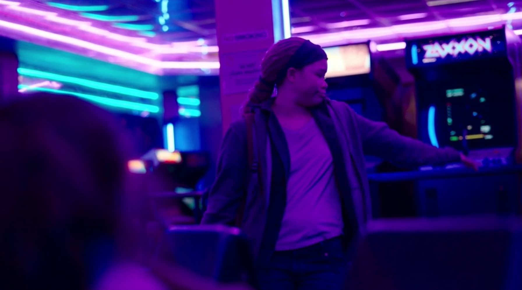 Person in neon-lit futuristic room with purple and blue lighting