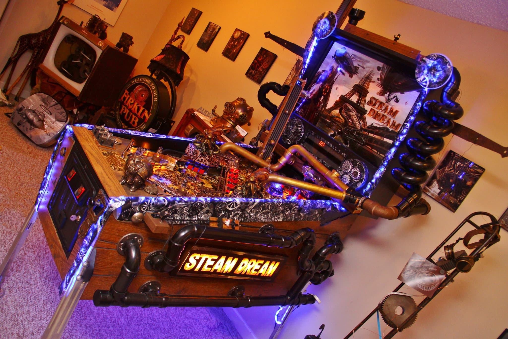 Steampunk-themed custom computer setup with blue LED lighting and intricate pipes