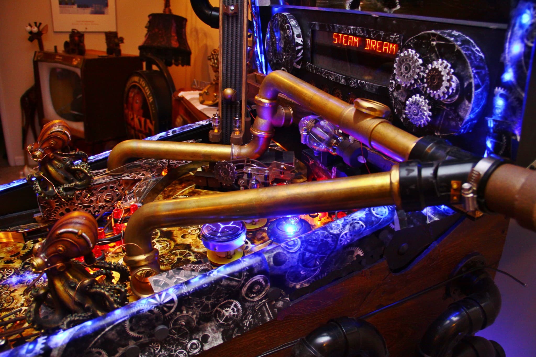 Steampunk-inspired machine with golden pipes, gears, and blue glowing lights