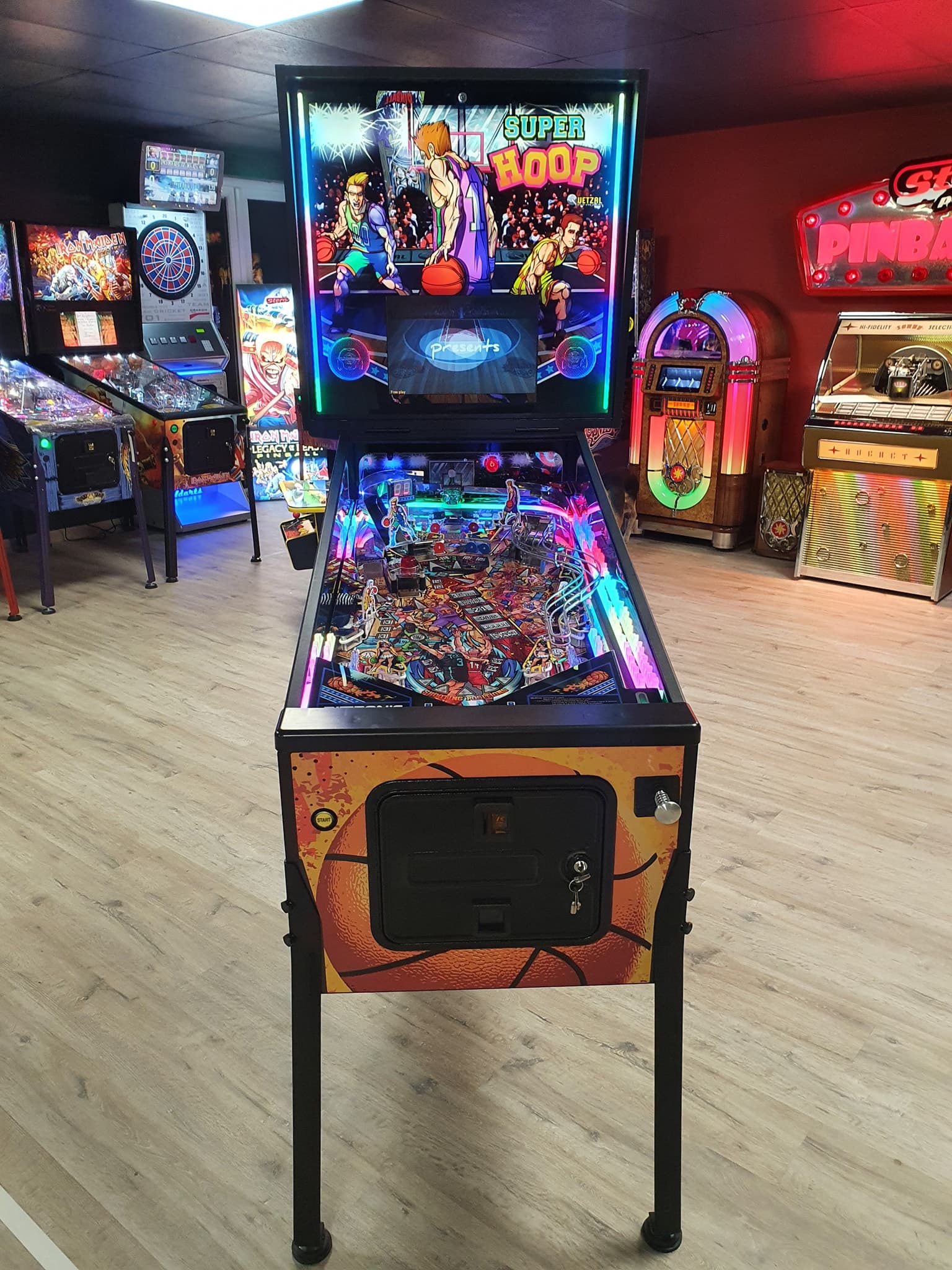 Super Hoop pinball machine with colorful lights in retro arcade
