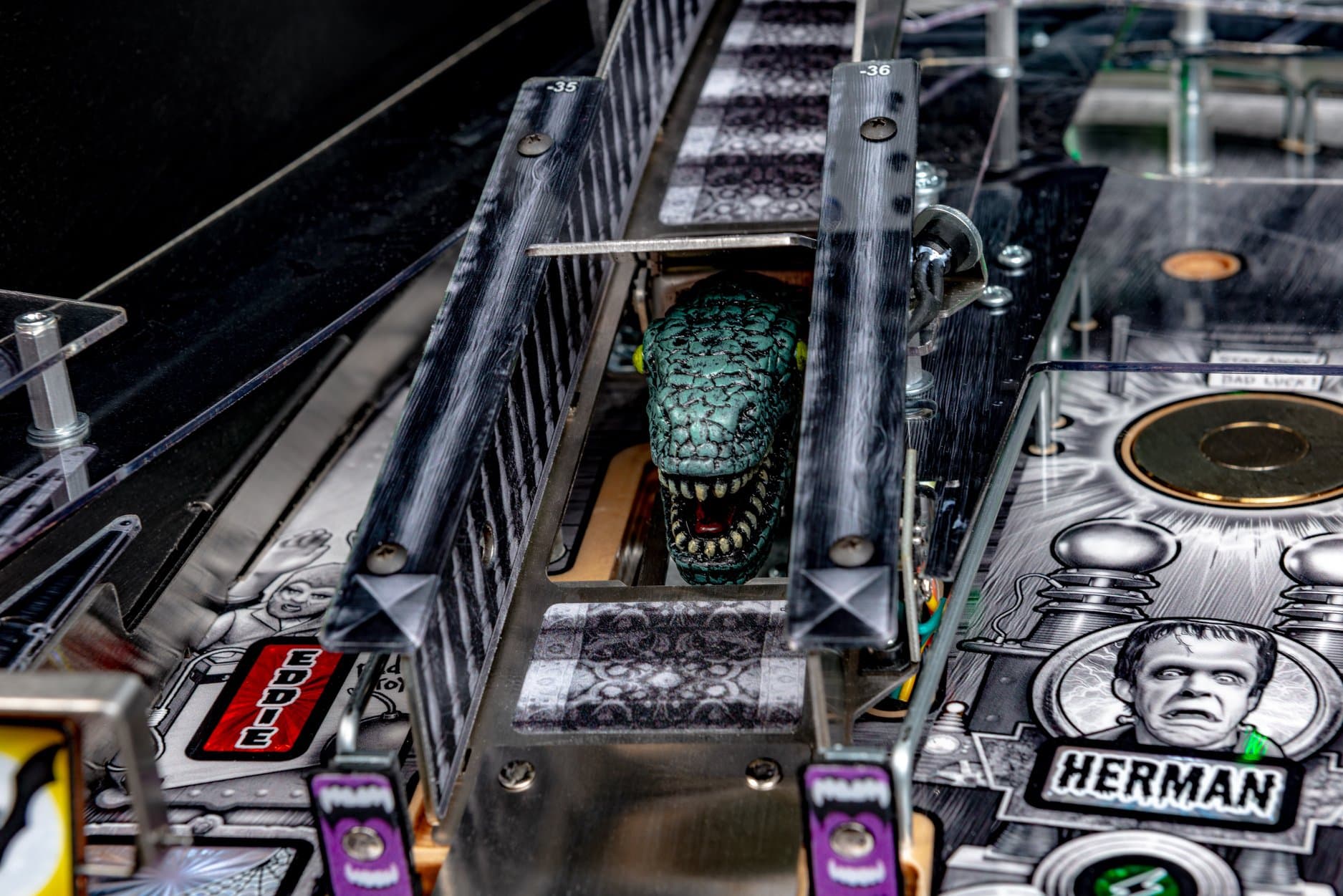 Scary monster head on a complex pinball machine with numbered markers