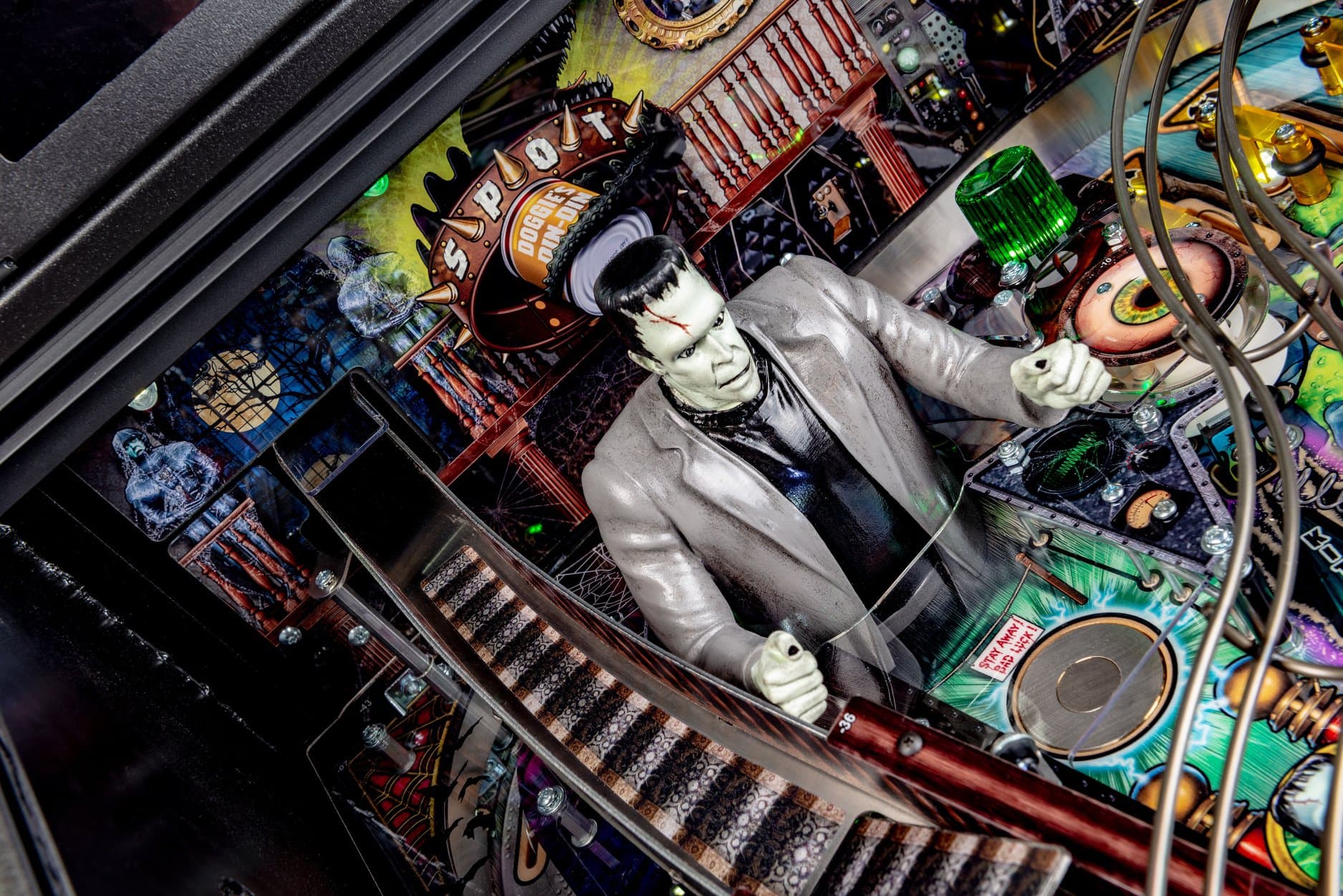 Frankenstein's monster on colorful pinball machine with complex electronic background