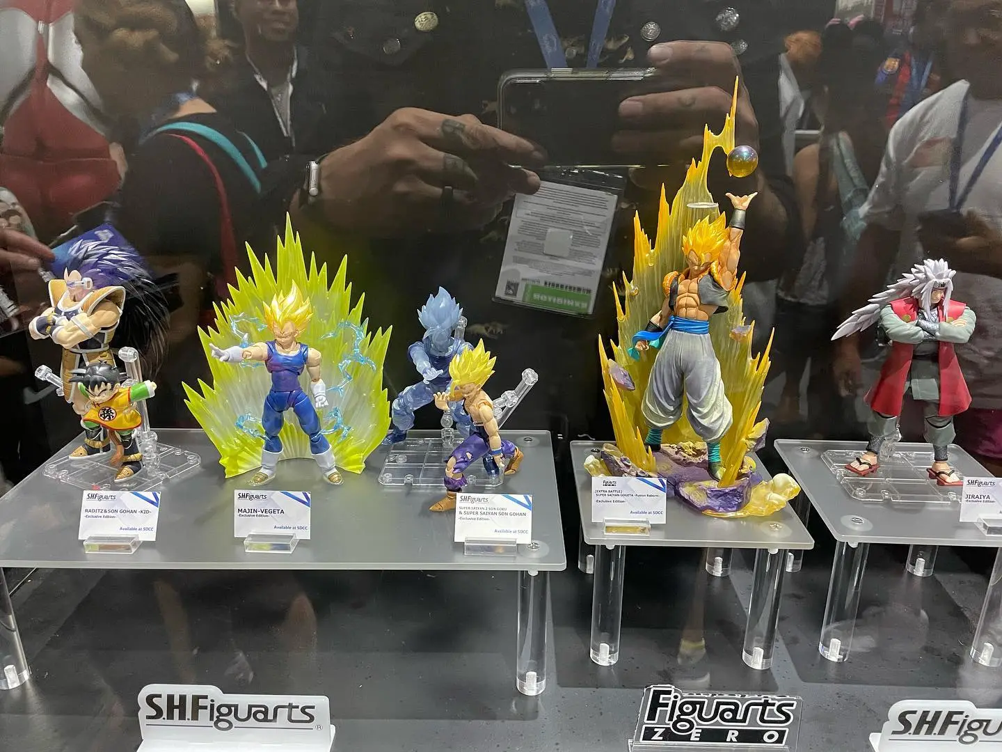 Dragon Ball action figures on display with energy effects at convention