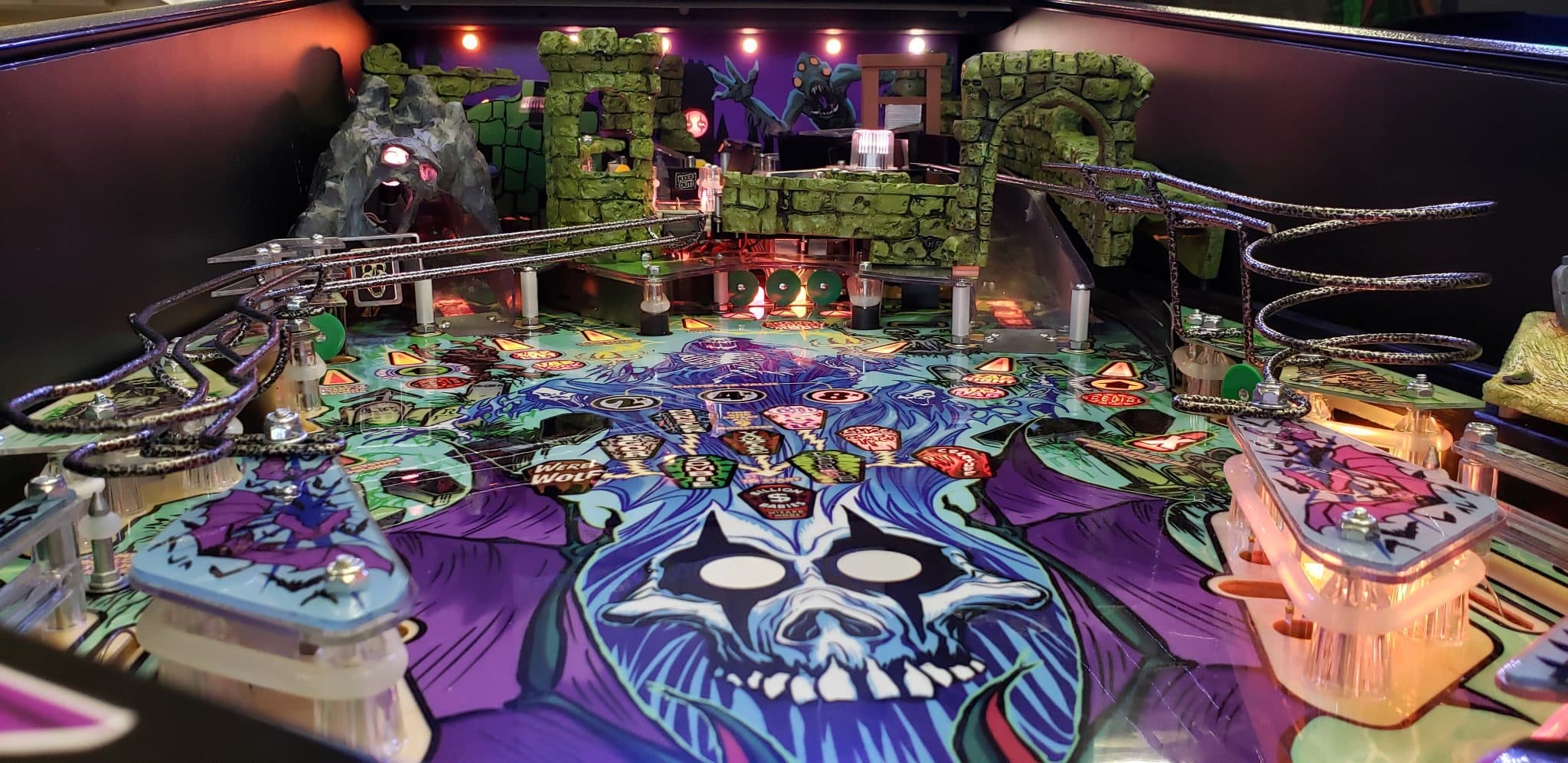 Colorful fantasy pinball machine with stone castle and skull design