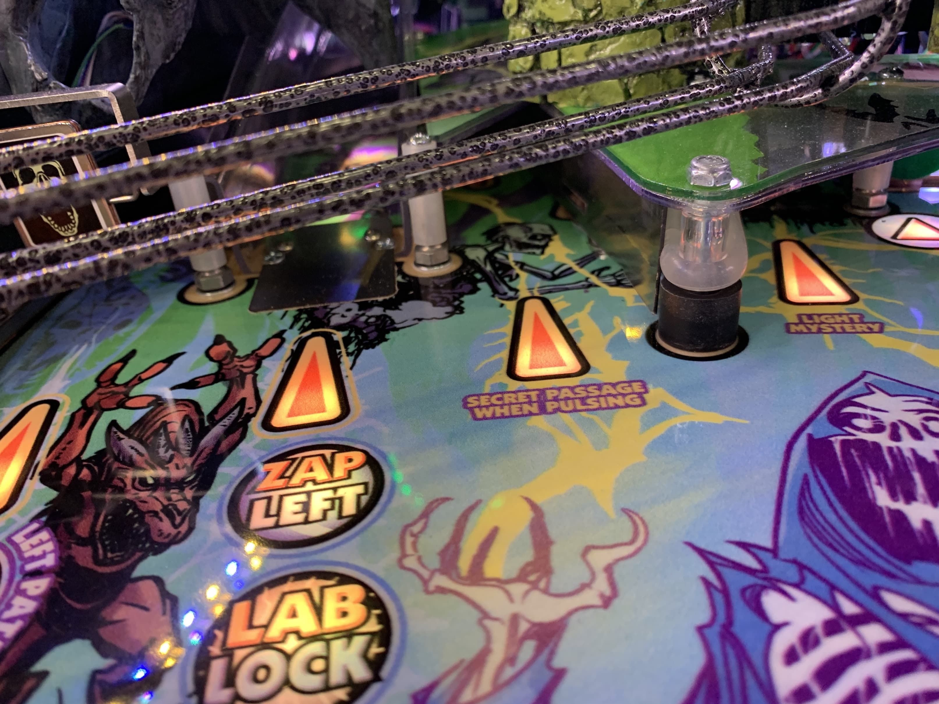 Colorful pinball machine playfield with glowing elements and game instructions