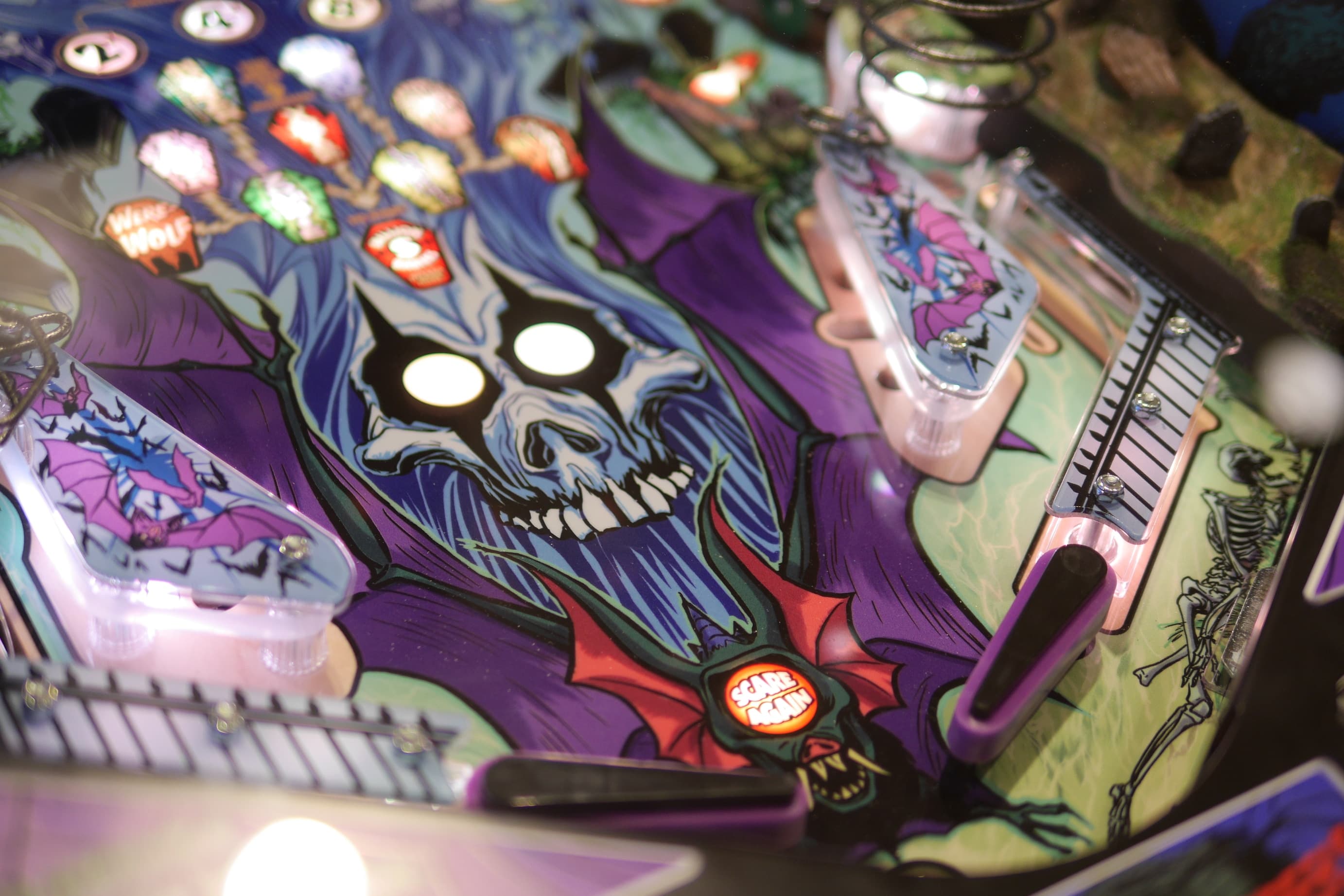 Colorful pinball machine with spooky skull and bat design