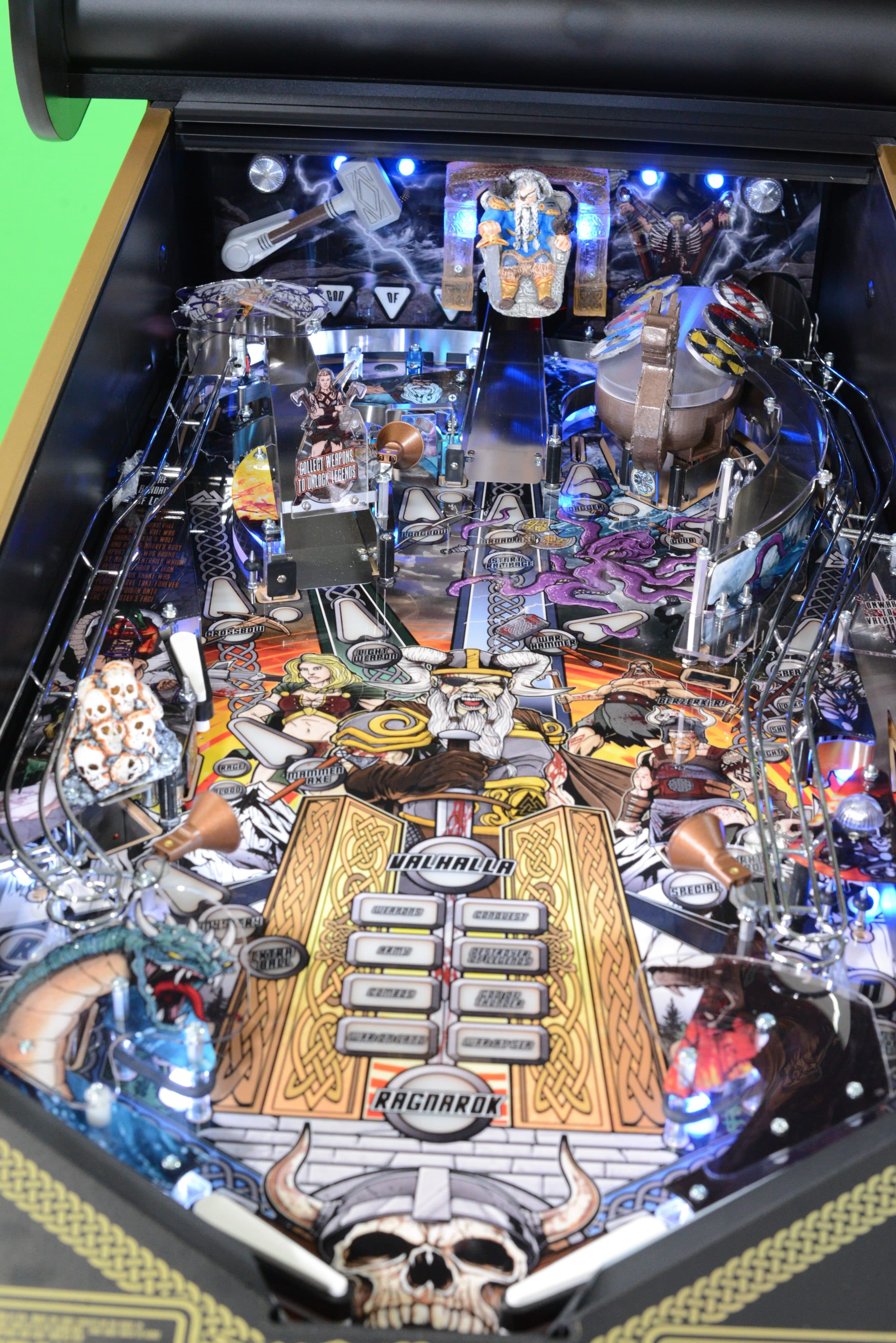 Detailed Ragnarok-themed pinball machine with intricate Norse mythology artwork
