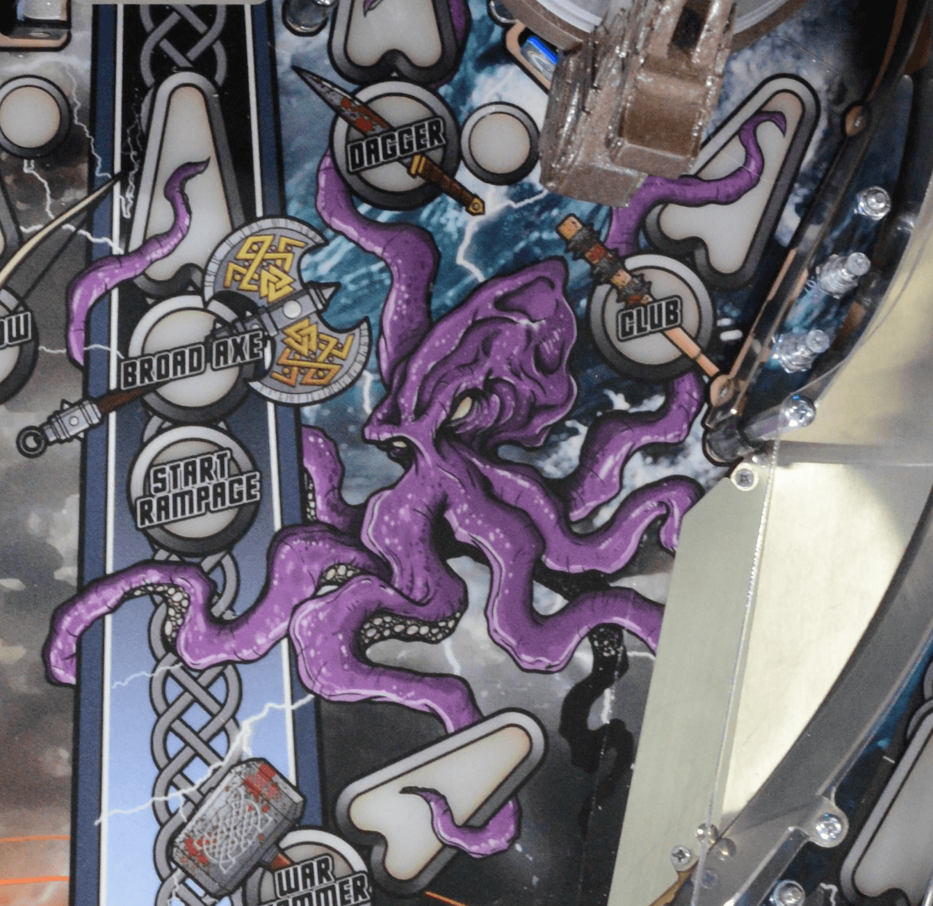 Purple octopus-like creature on mechanical pinball machine with game buttons