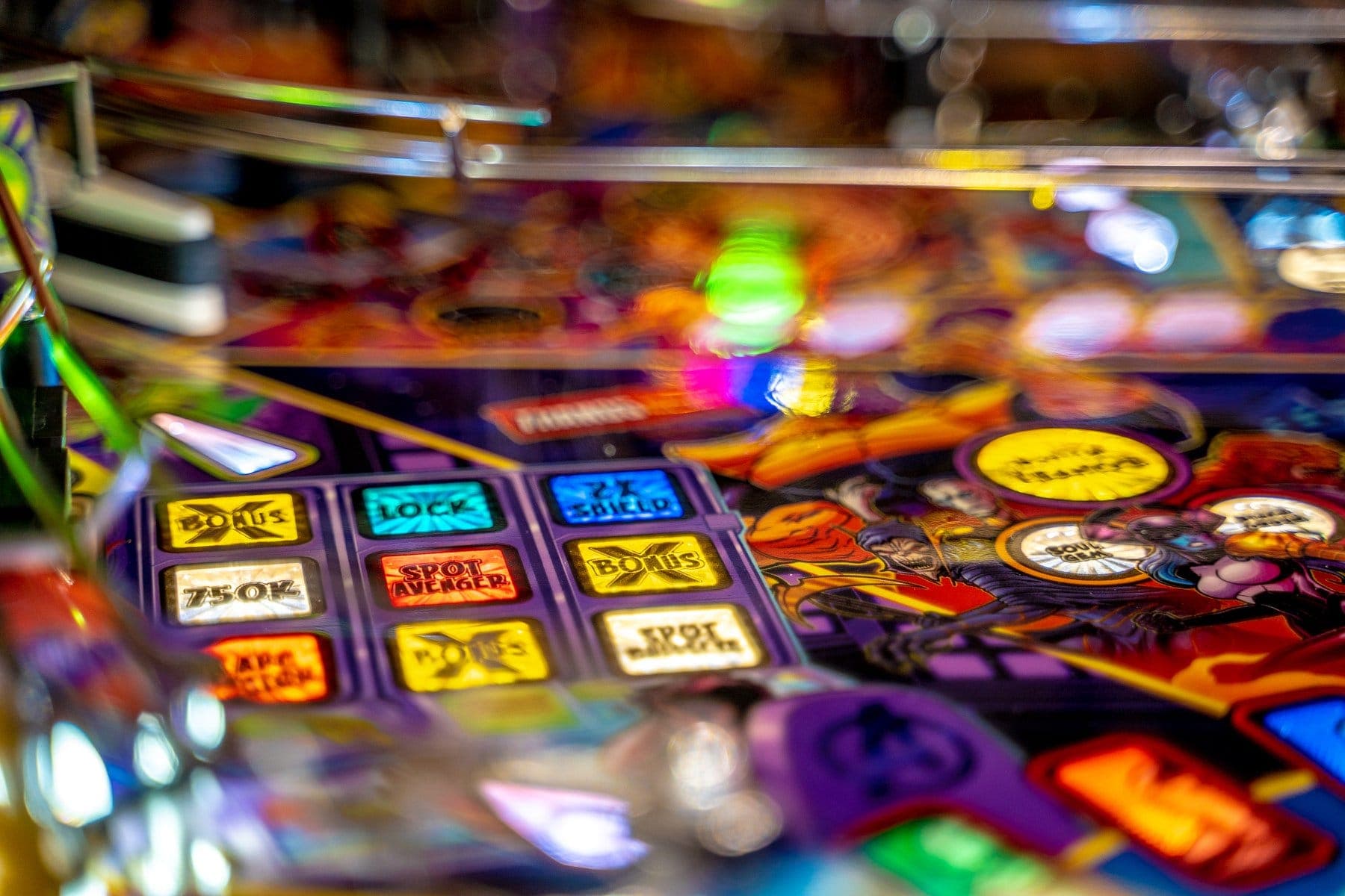 Colorful pinball machine with illuminated buttons and blurred motion