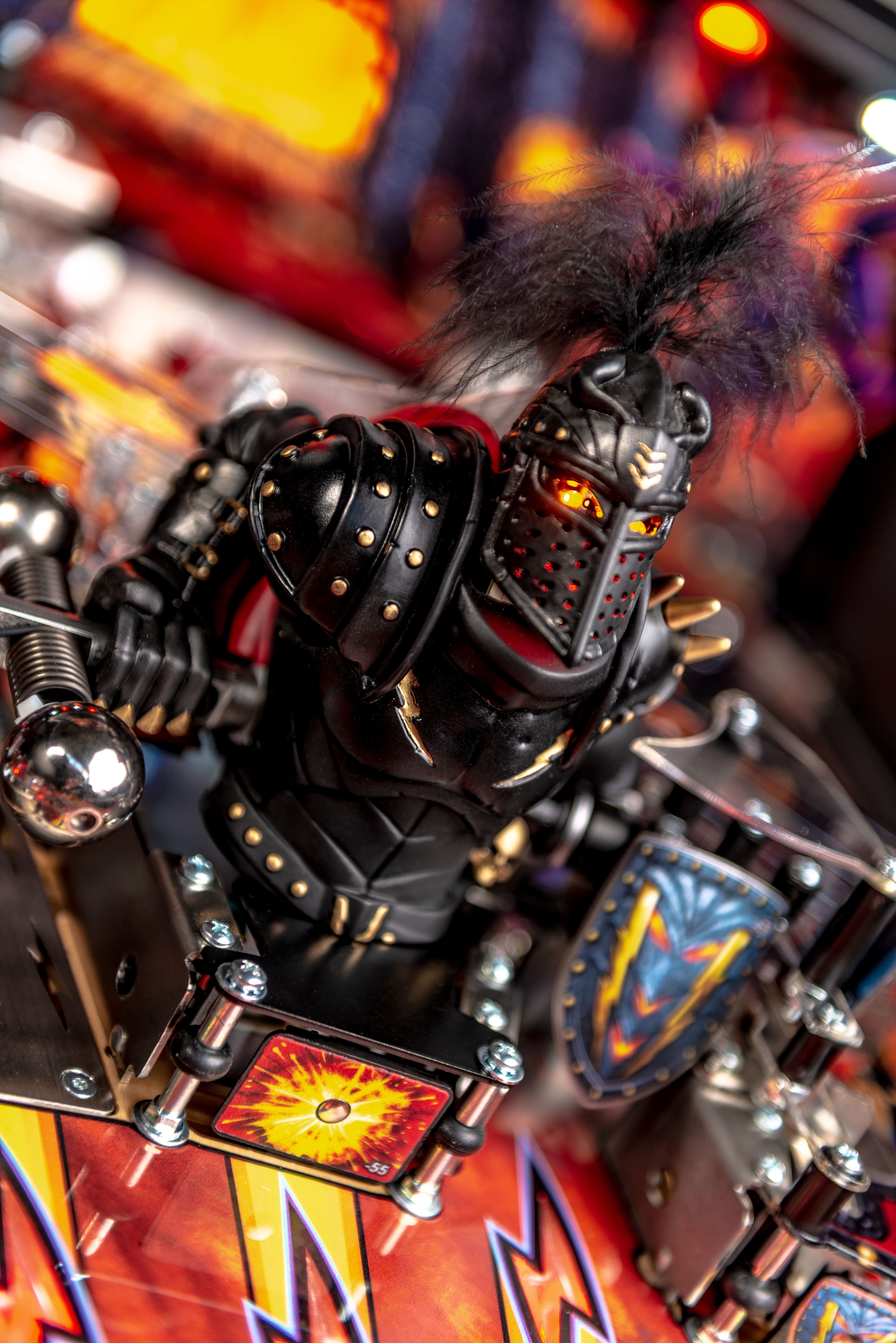 Black knight warrior figure with glowing details on colorful pinball machine