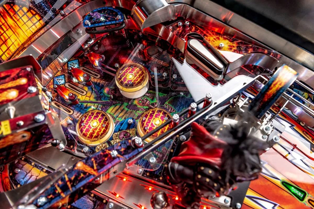 Colorful pinball machine interior with glowing targets and intricate mechanical details