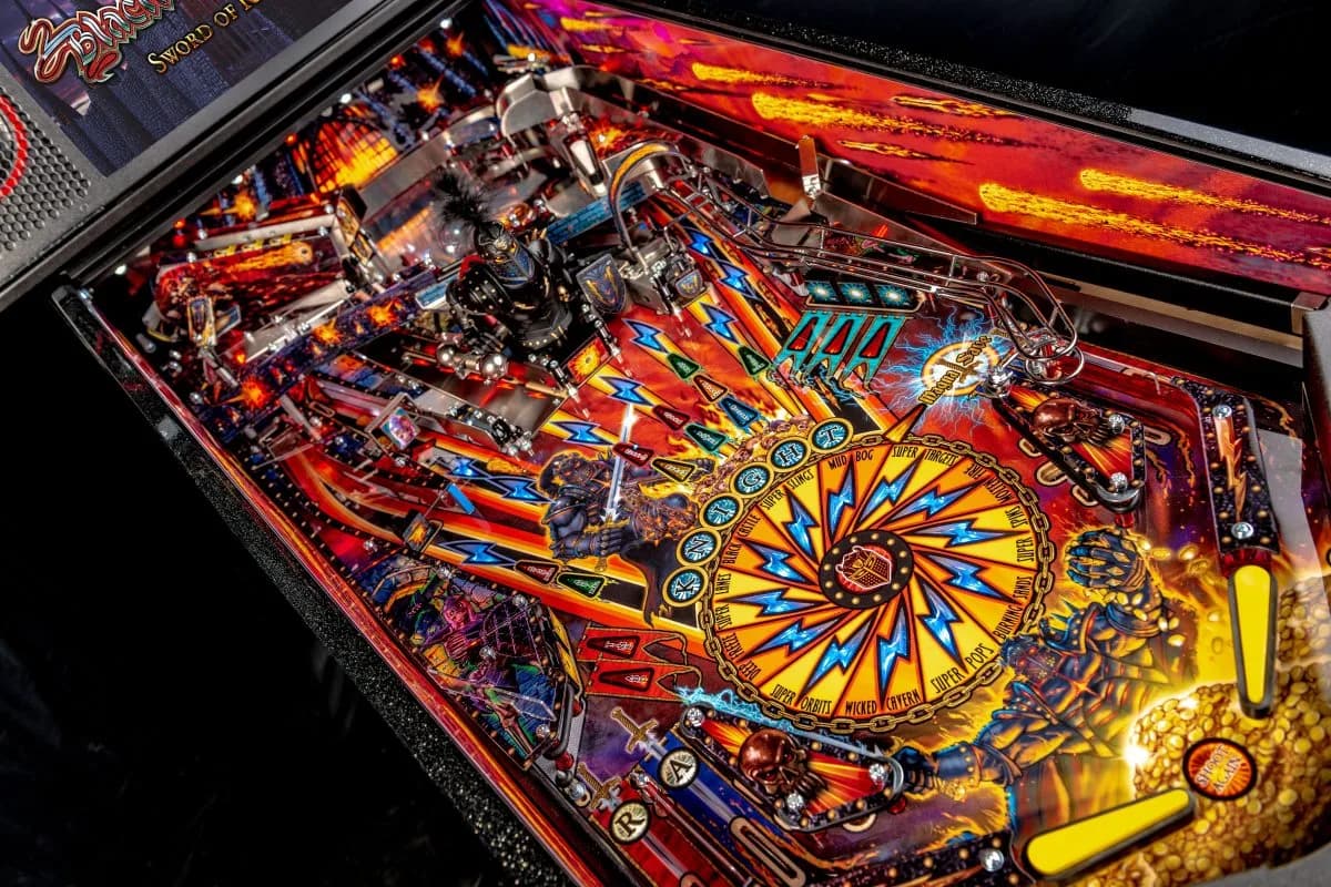 Colorful pinball machine with intricate design and spinning wheel centerpiece