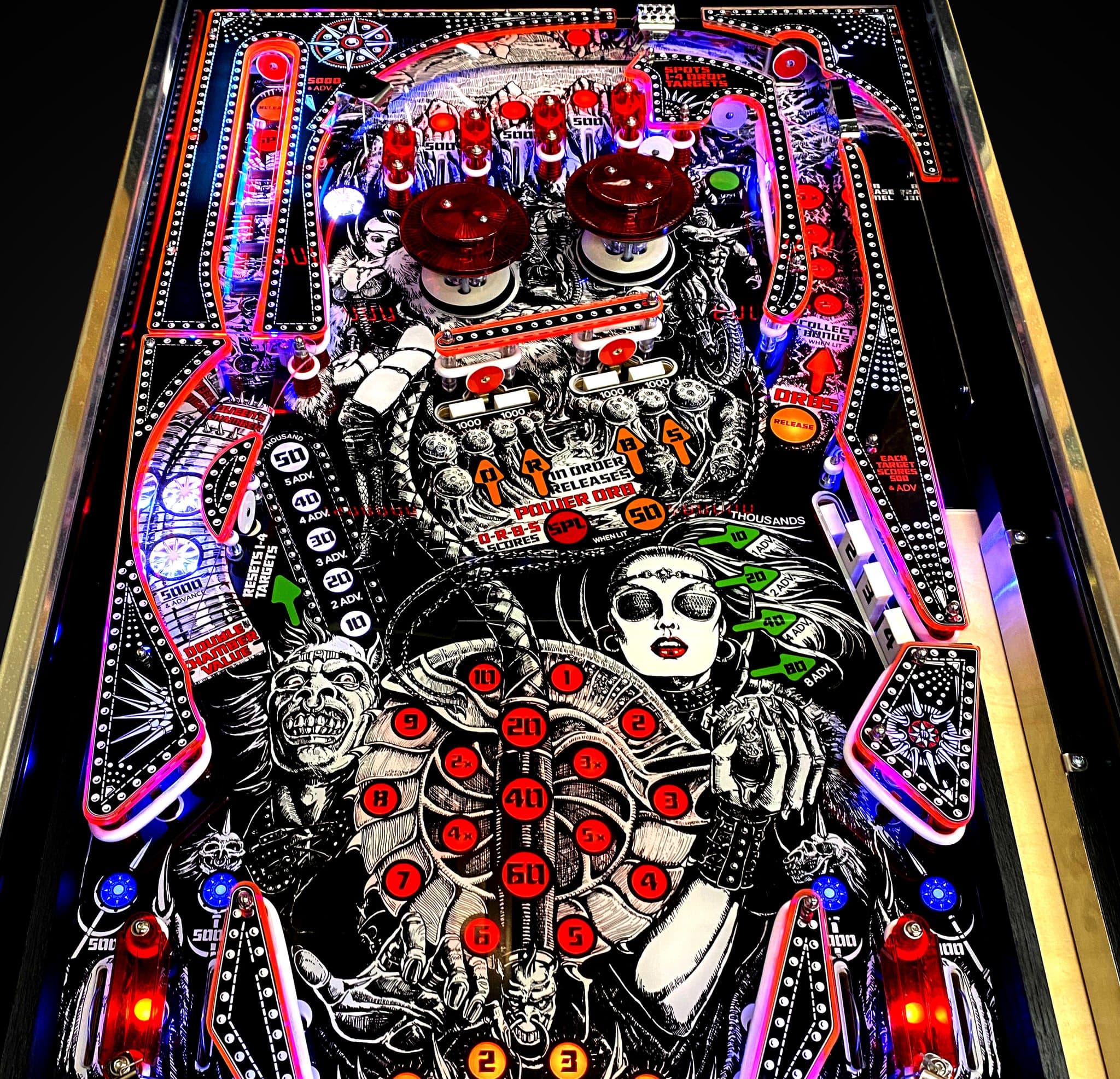 Colorful pinball machine playfield with gothic-style artwork and red highlights