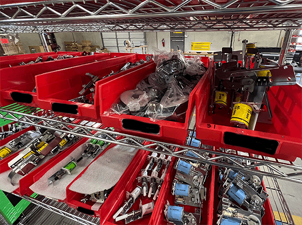 Red storage shelves with mechanical parts and industrial components