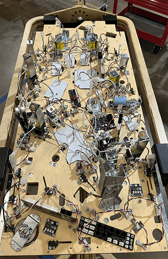 Complex electronic pinball machine circuit board with intricate wiring and components