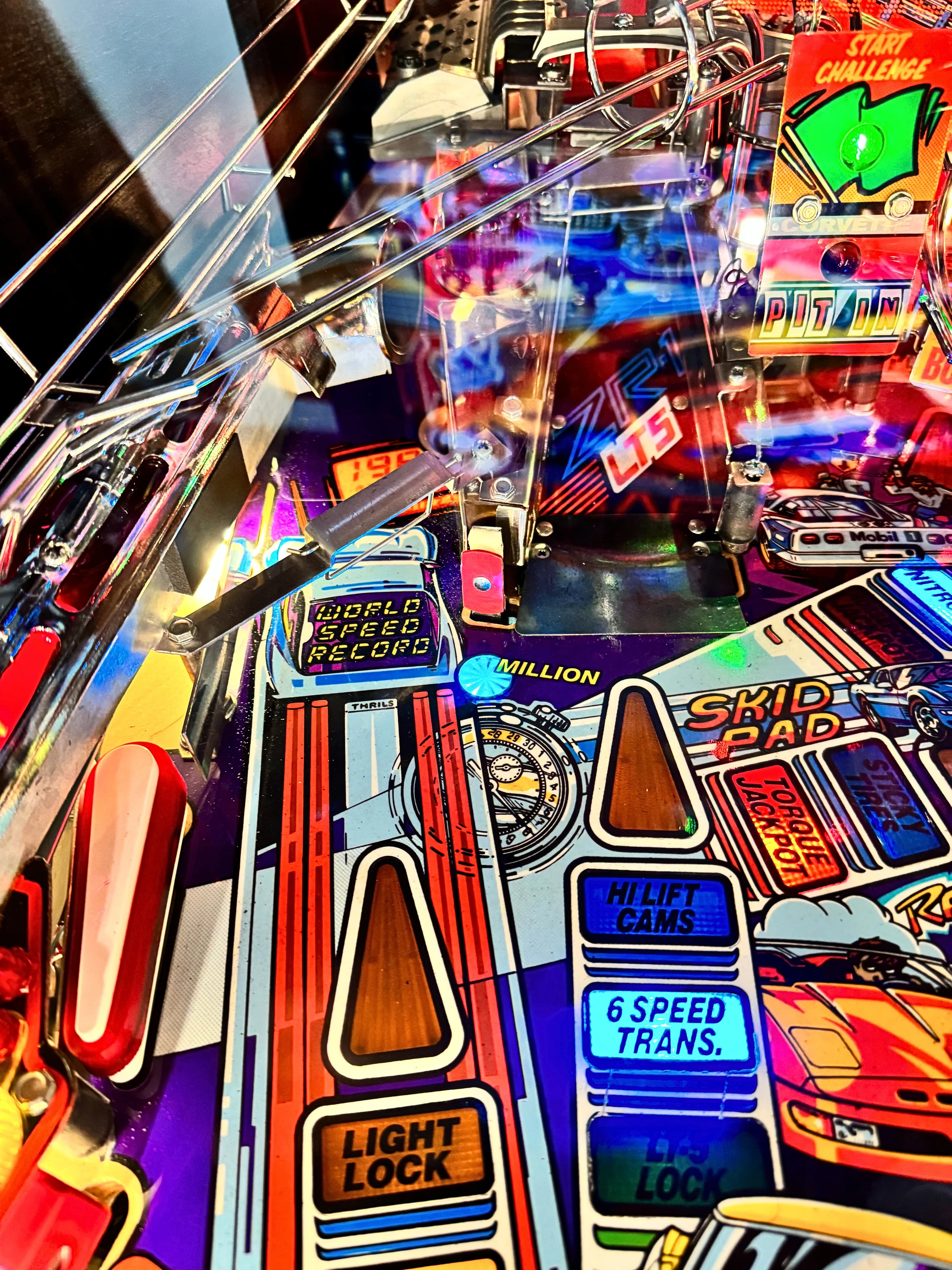 Colorful vintage pinball machine with multiple game features and bright graphics