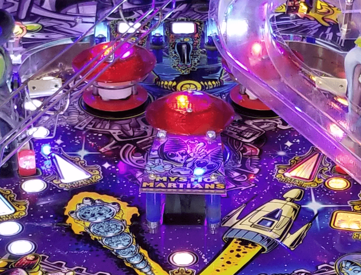 Colorful Mystic Martians pinball machine with glowing purple and red lights