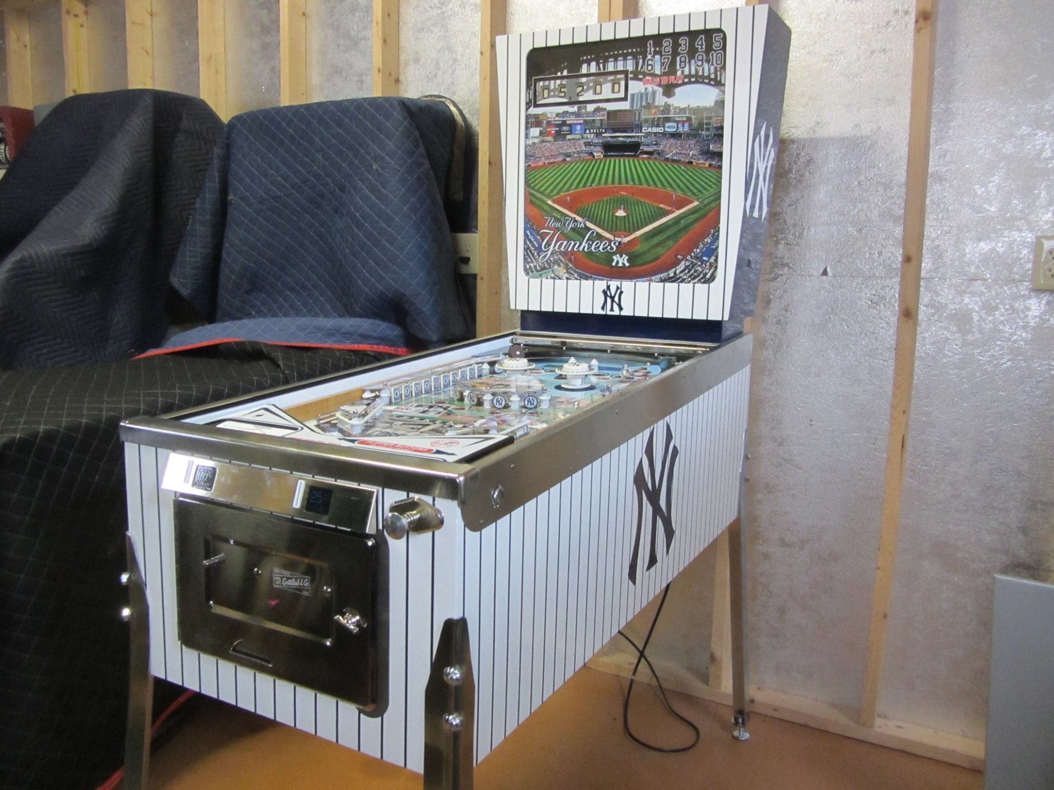 New York Yankees themed pinball machine with stadium poster