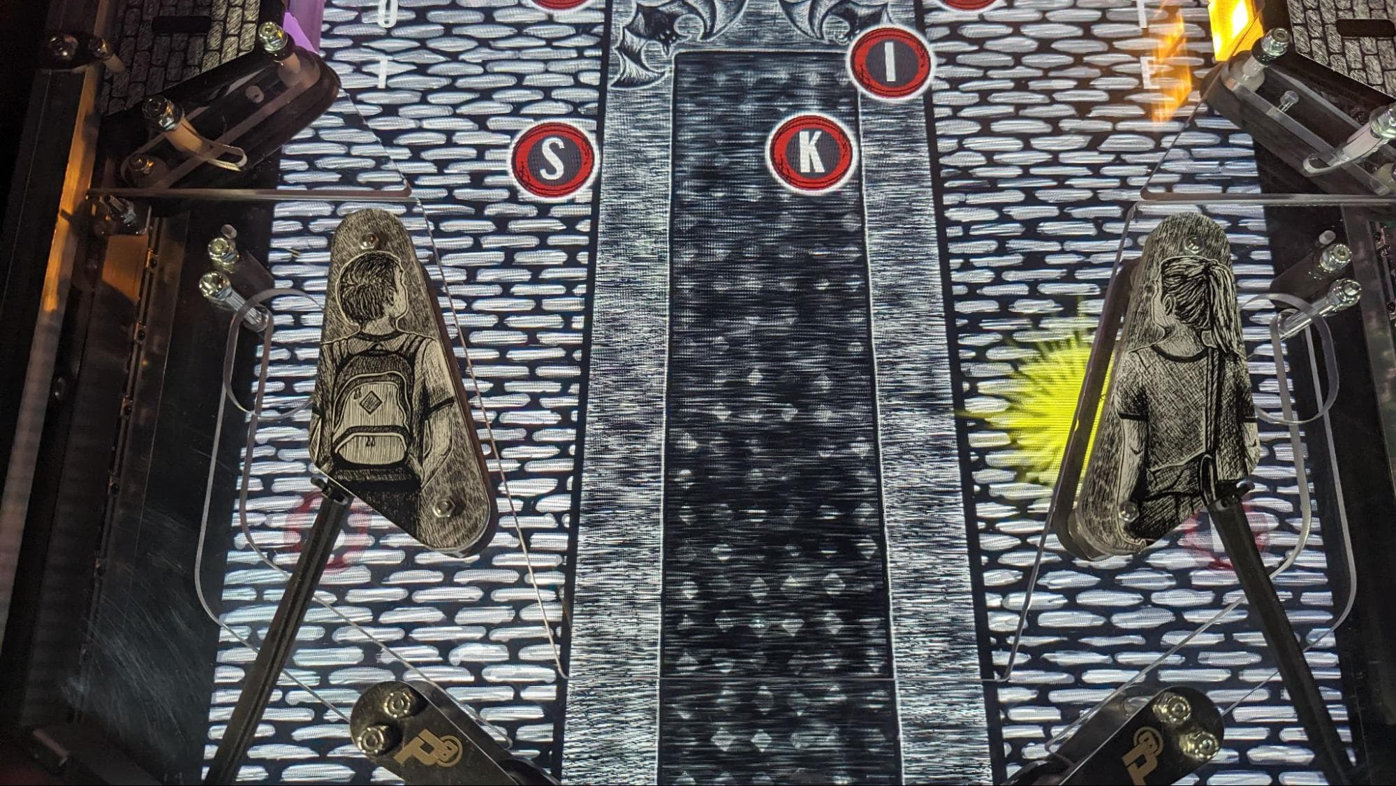 Arcade game control panel with letters S, I, K and illuminated buttons