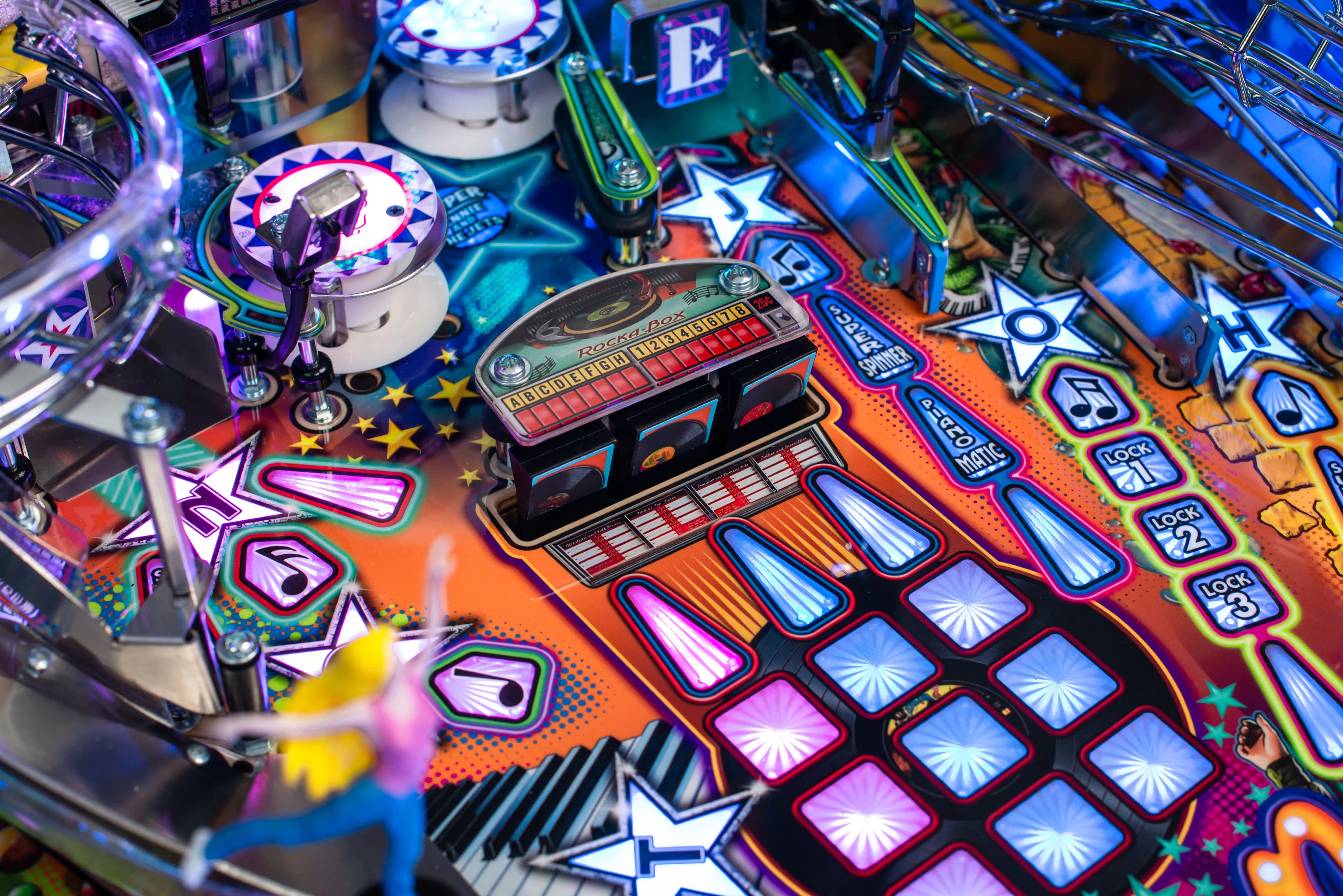 Colorful pinball machine playfield with vibrant buttons and electronic display