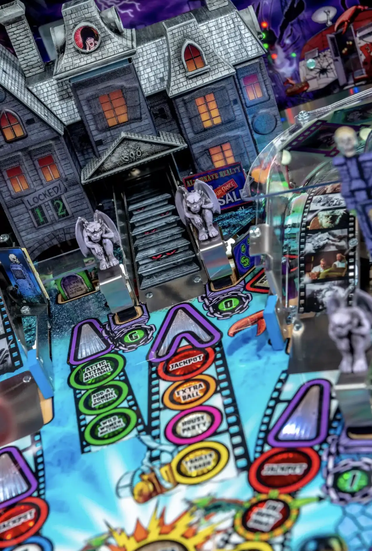 Spooky haunted house pinball machine with gargoyles and colorful game targets