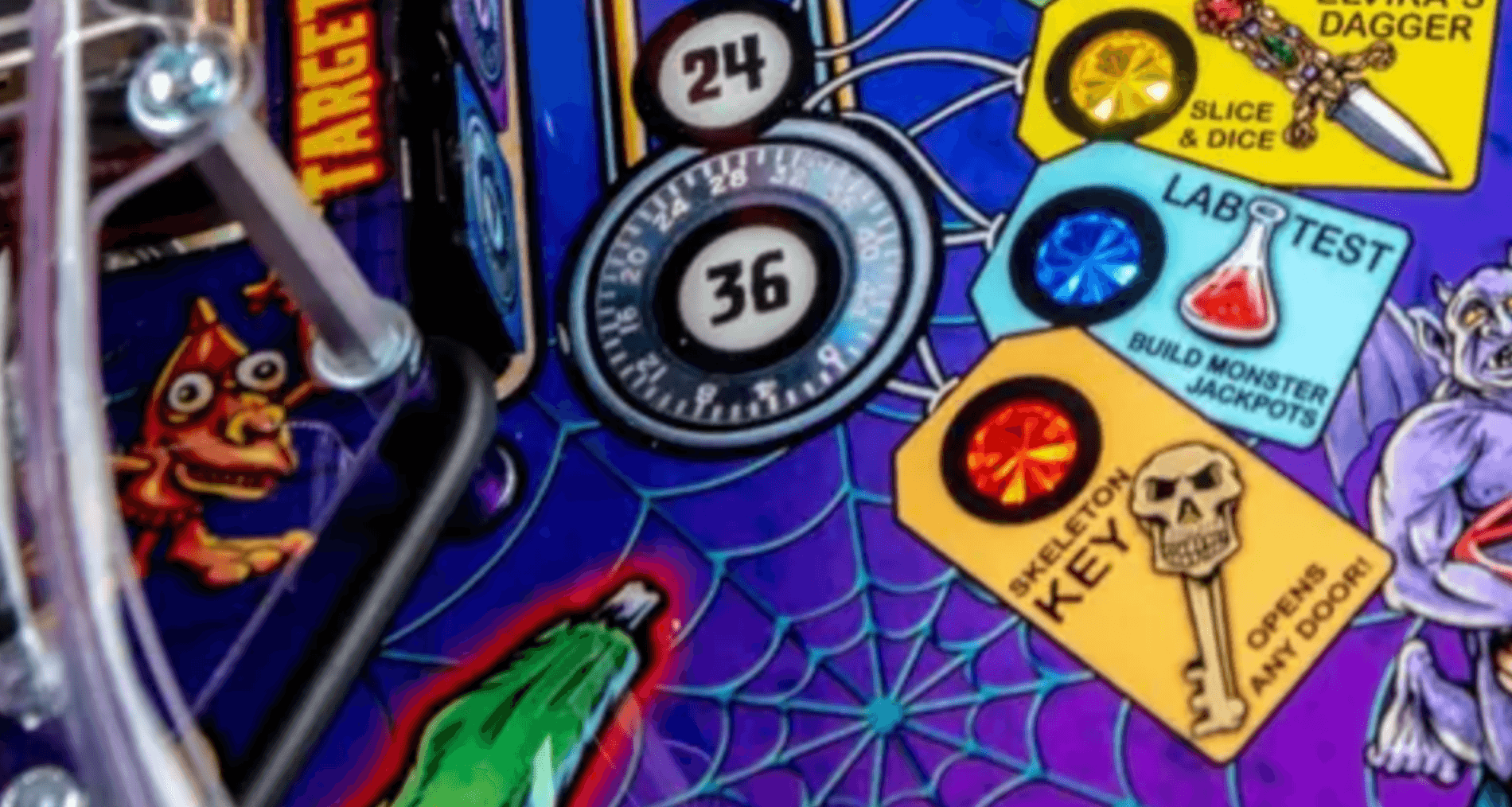 Colorful pinball machine details with spiderweb, numbers, and cartoon characters