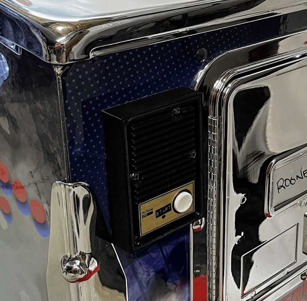 Vintage control panel with chrome edges and black speaker on blue background