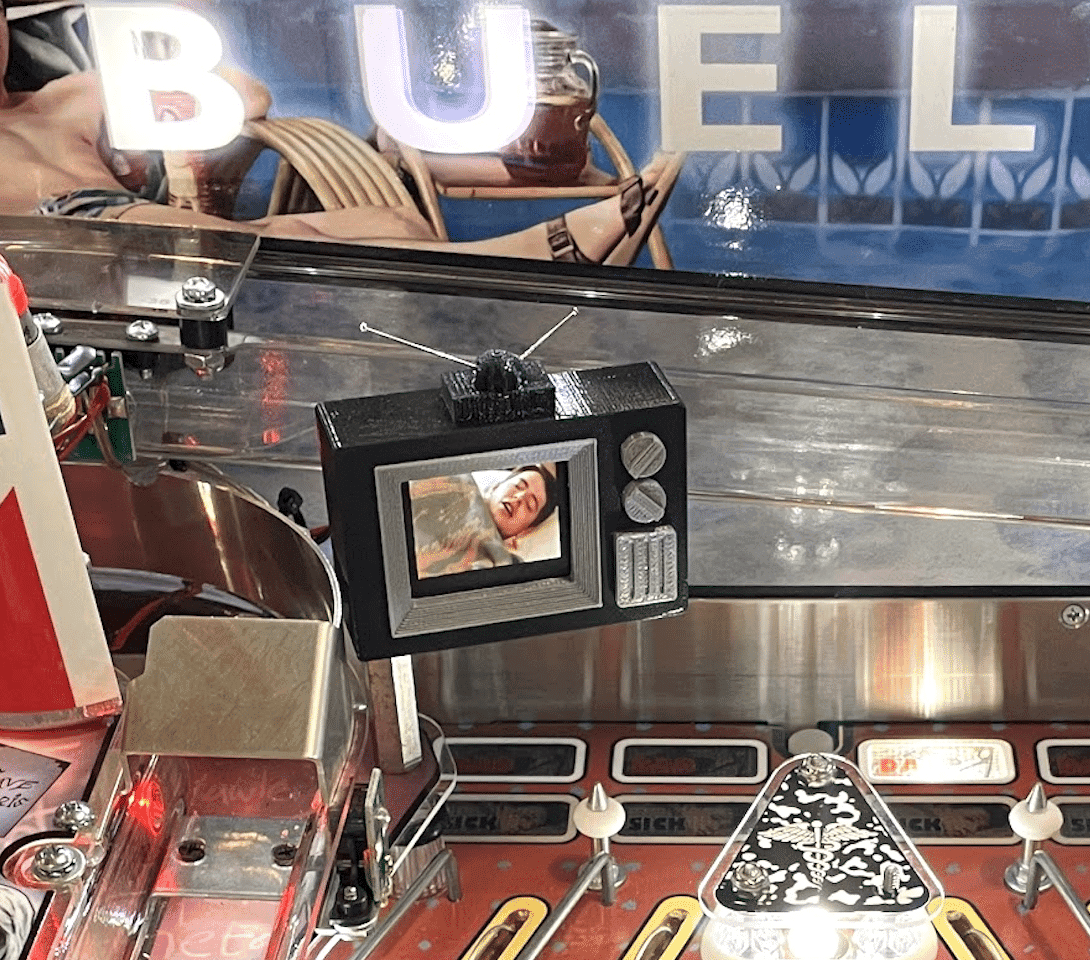 Vintage TV screen displays person inside pinball machine with BUBEL letters