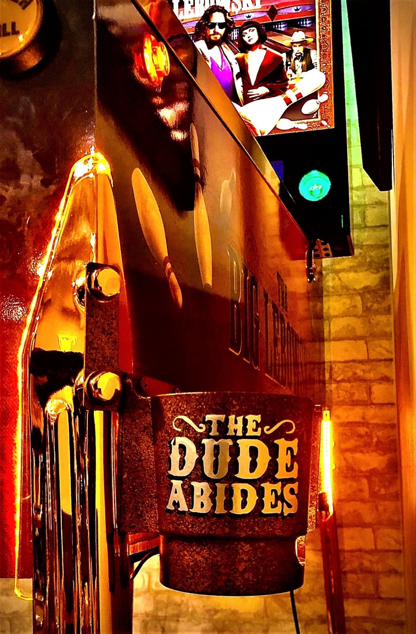 The Dude Abides sign with glowing lights from The Big Lebowski