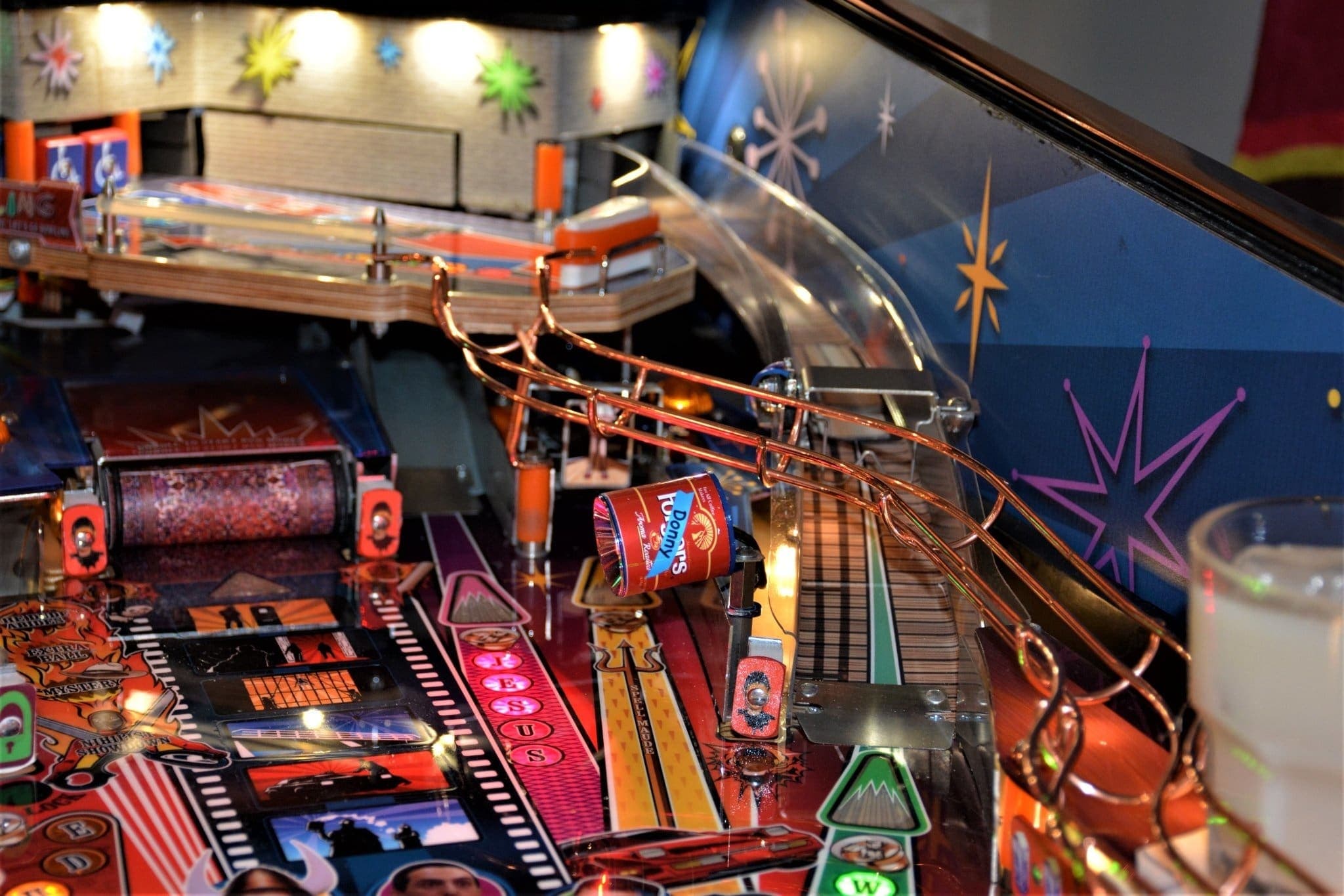 Colorful pinball machine with intricate metal tracks and blinking lights