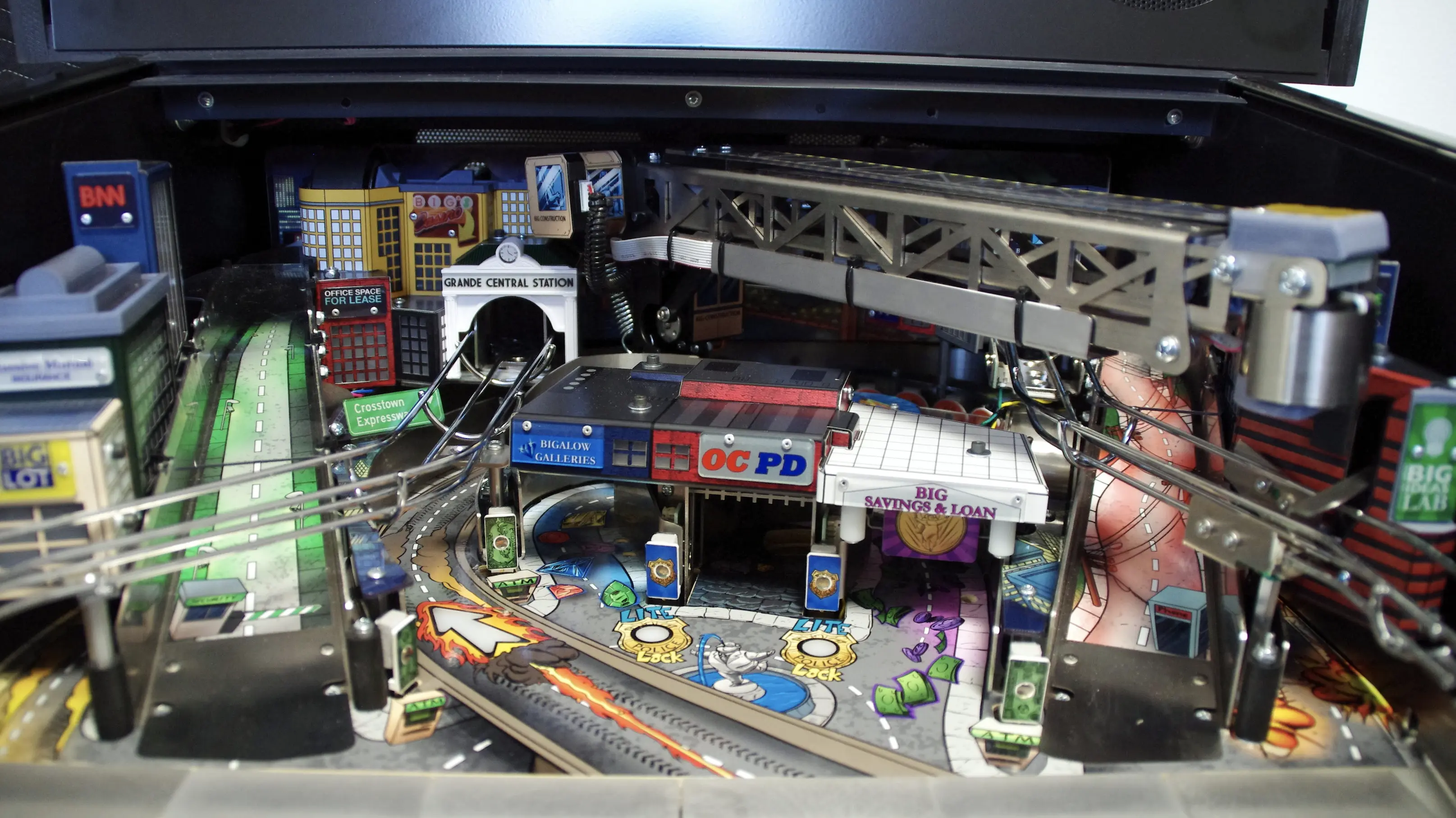 Detailed miniature city pinball machine with urban buildings and infrastructure