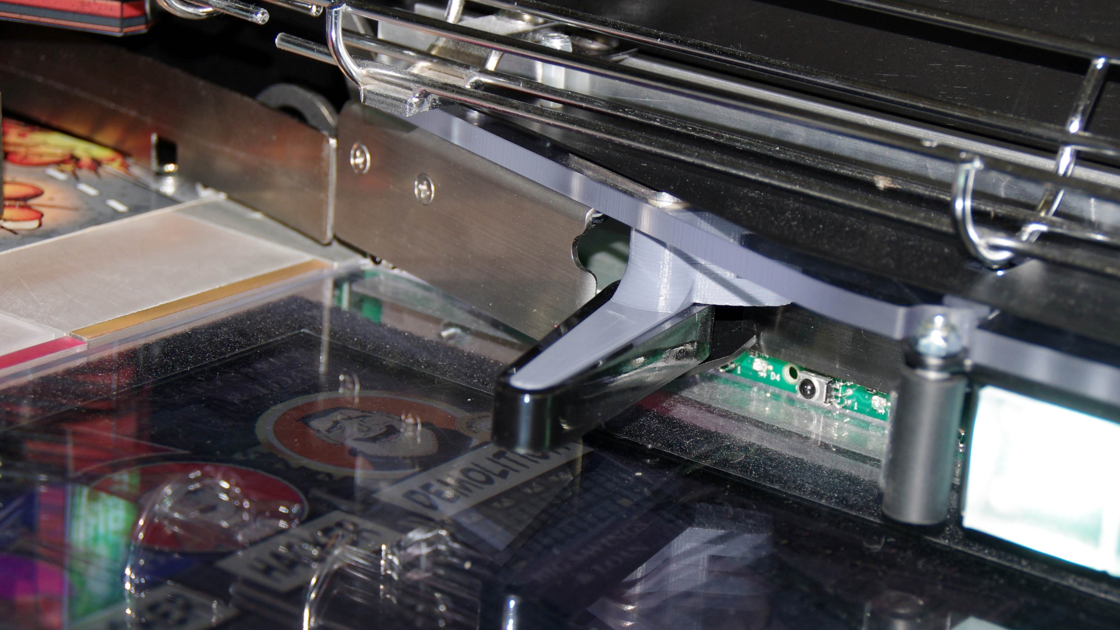 Close-up of printer mechanism with metallic parts and circuit board