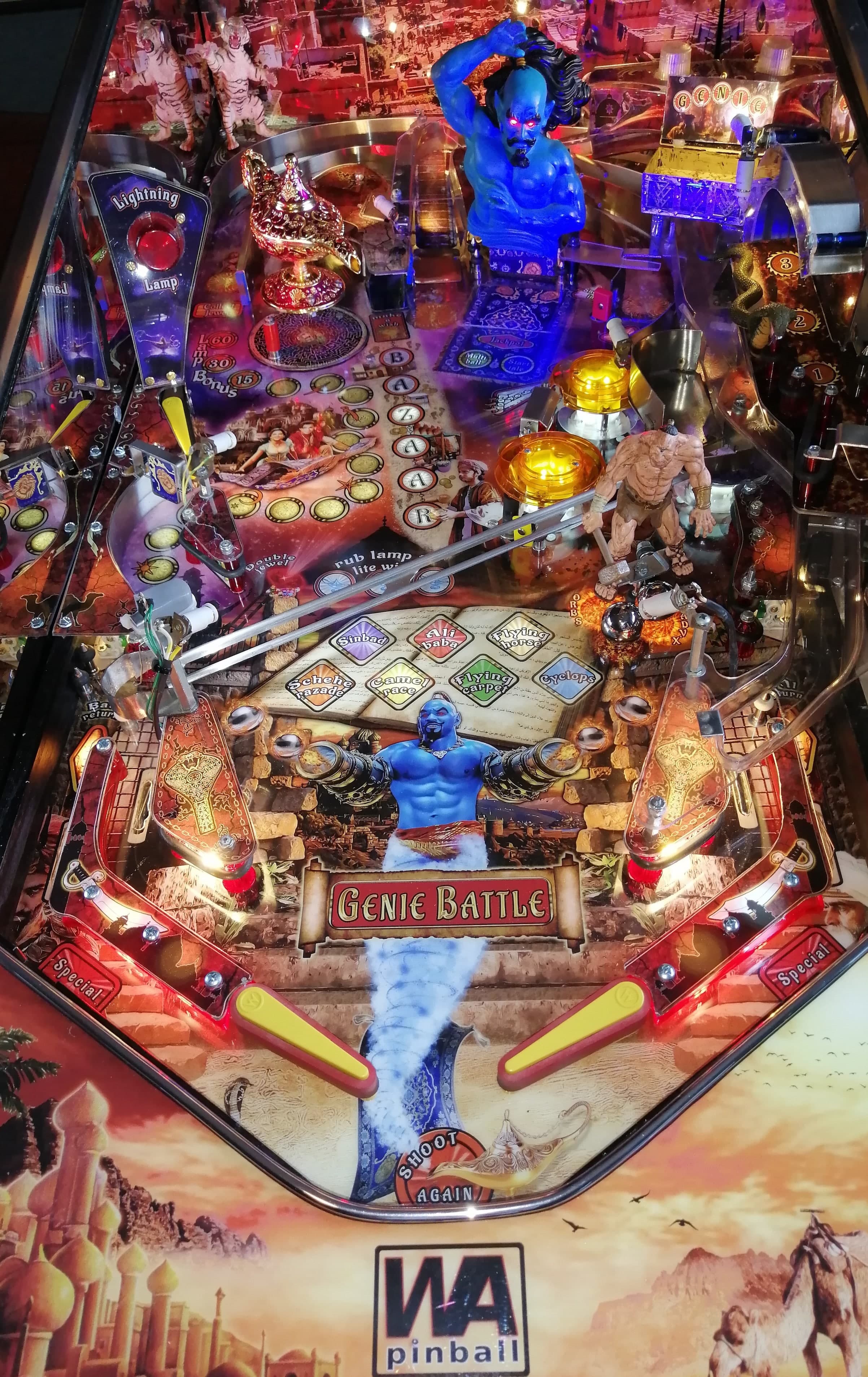 Genie Battle pinball machine with blue genie, colorful lights, and playfield