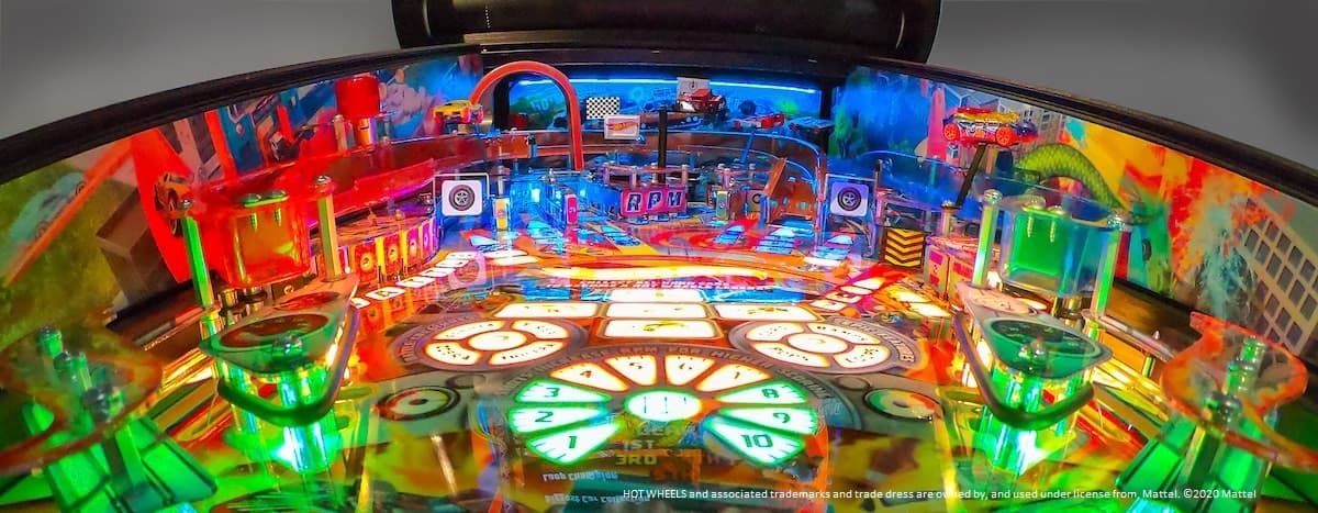 Colorful pinball machine with vibrant lights and intricate playfield design
