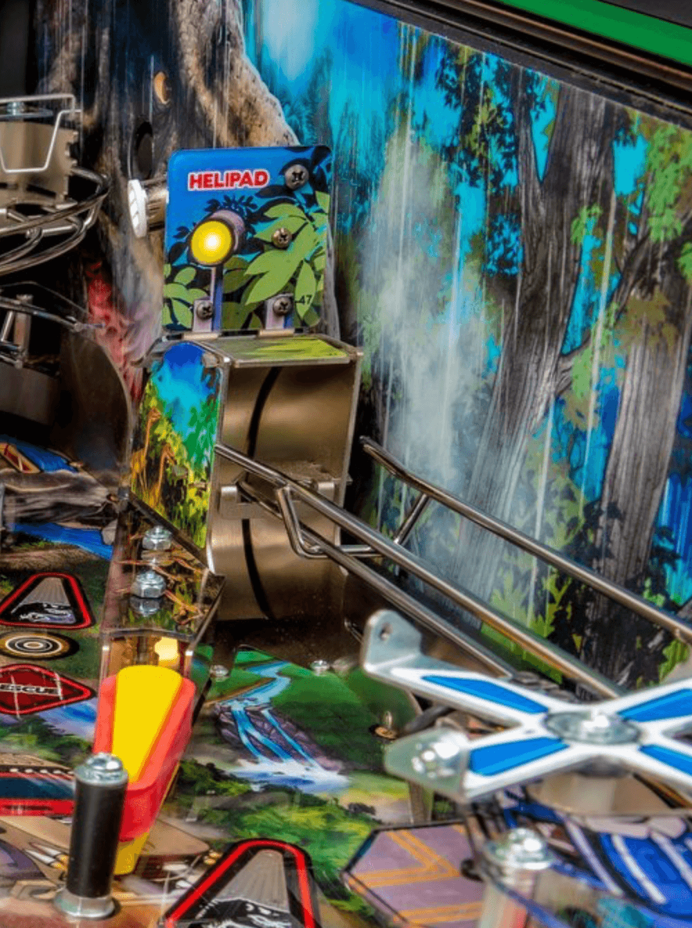 Closeup of pinball machine with Helipad mechanism and colorful forest background