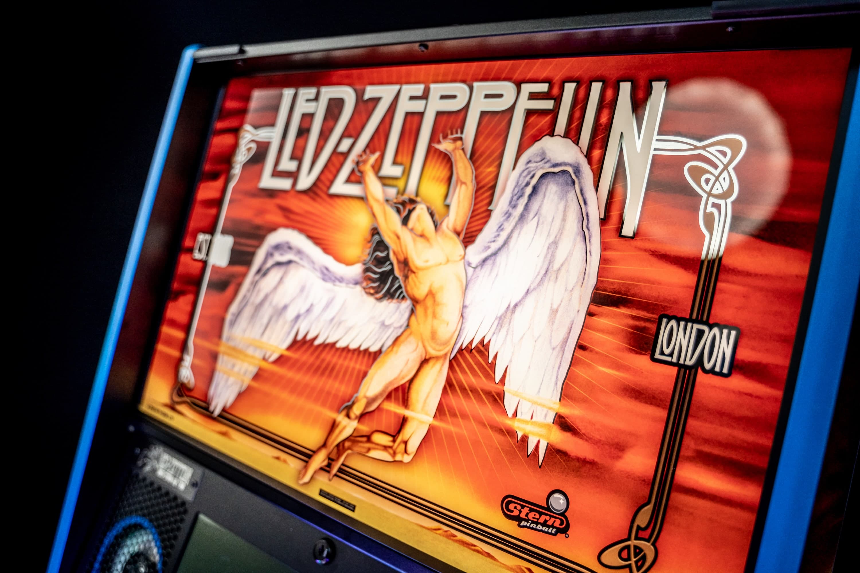 Led Zeppelin pinball machine with winged angelic figure on fiery background