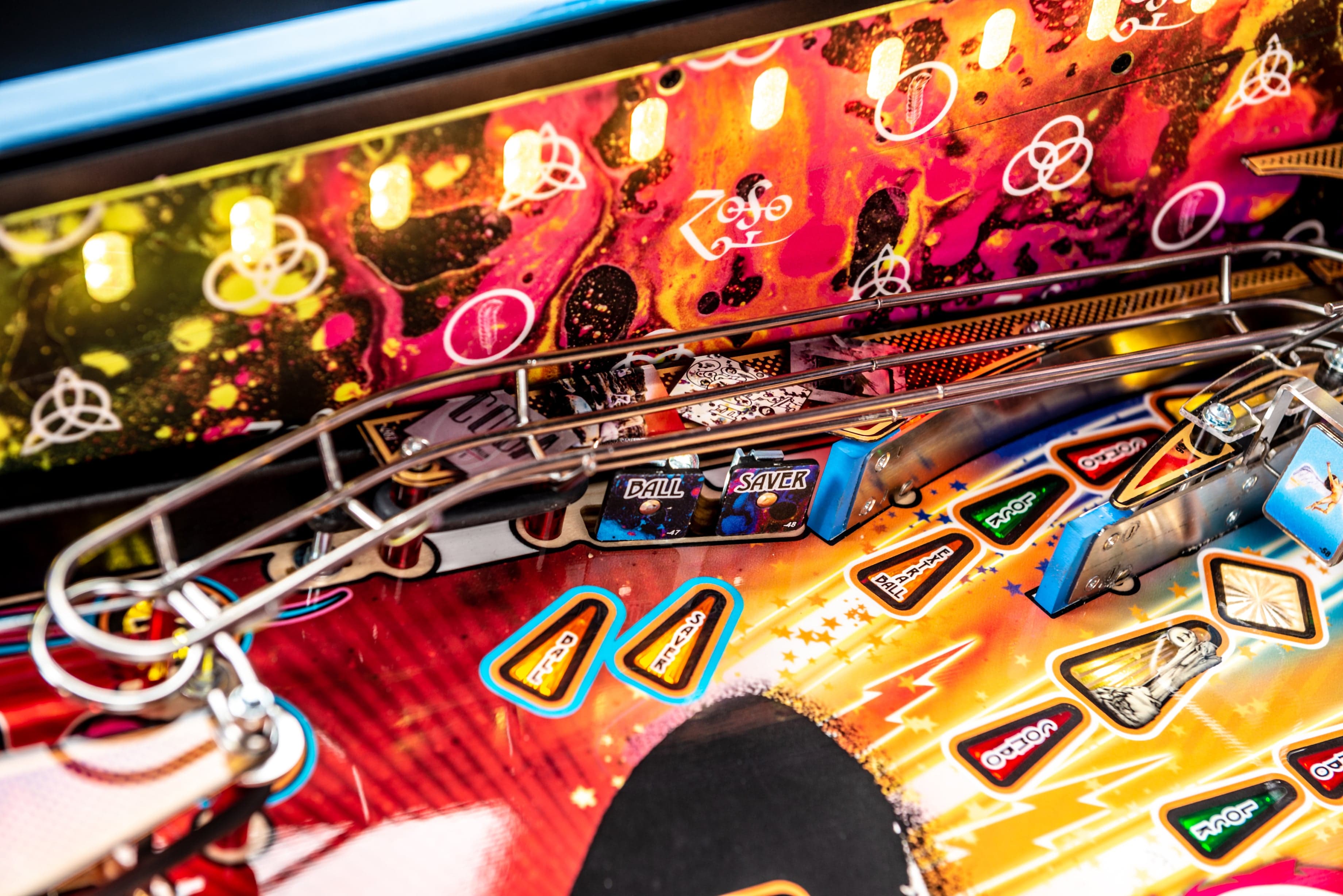 Colorful pinball machine with vibrant playfield and metallic rails