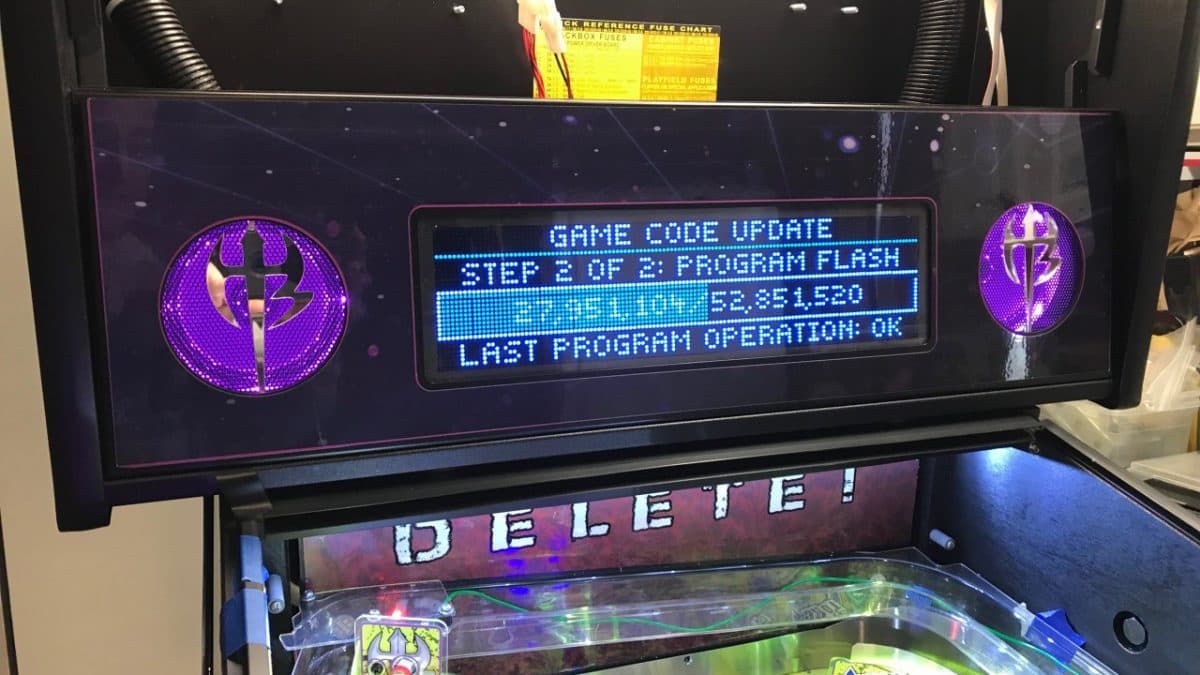 Arcade machine display showing game code update in progress