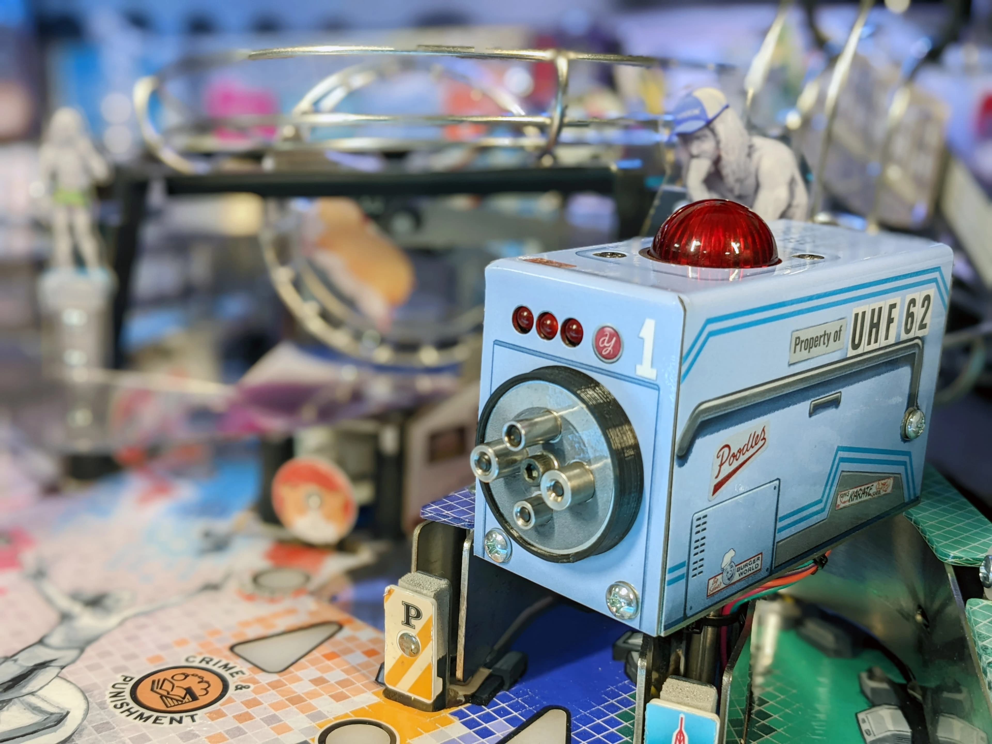 Vintage blue electronic device with red signal light, labeled UHF 62