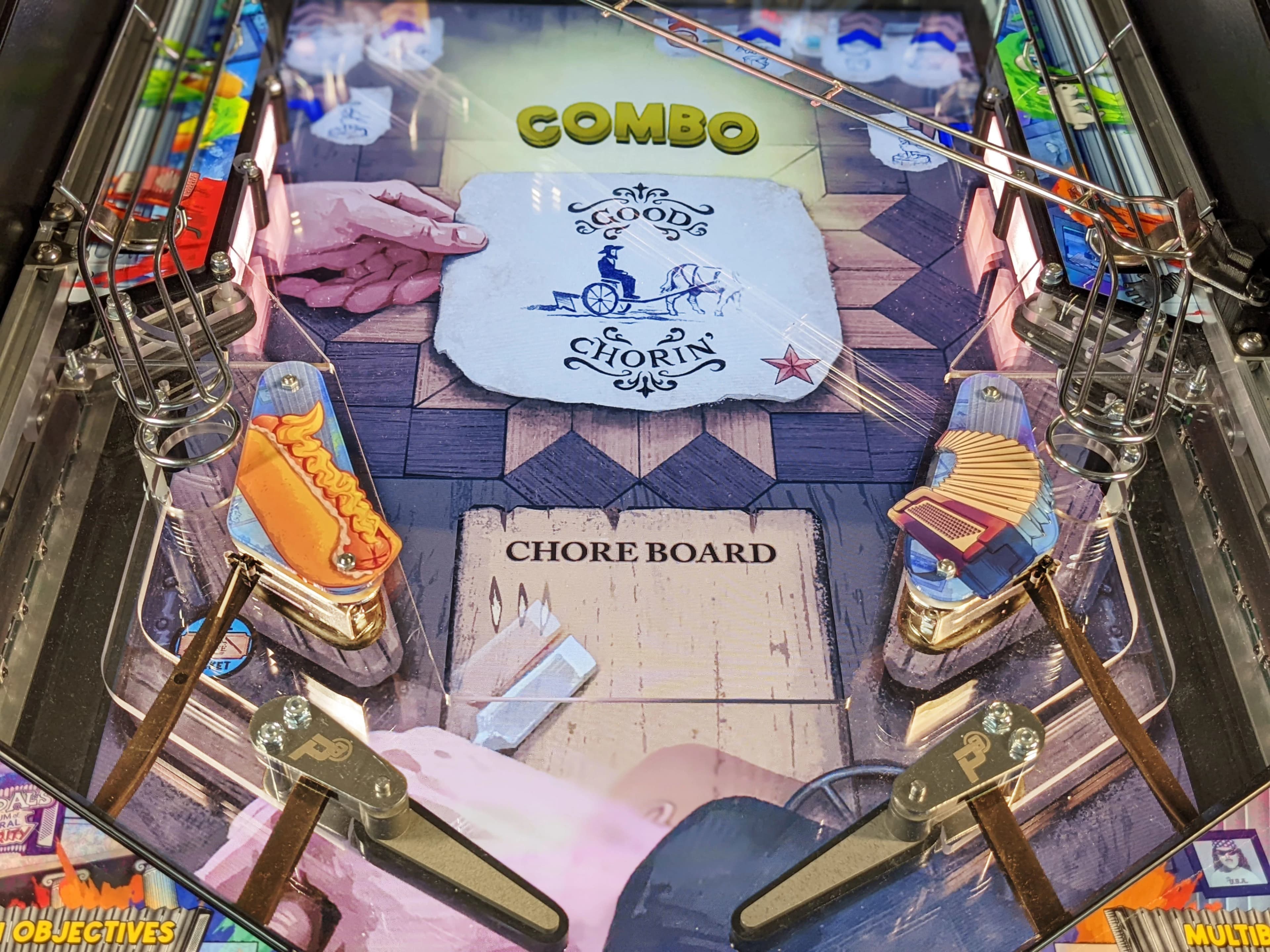 Pinball machine playfield with Chore Chorin theme and hot dog illustration