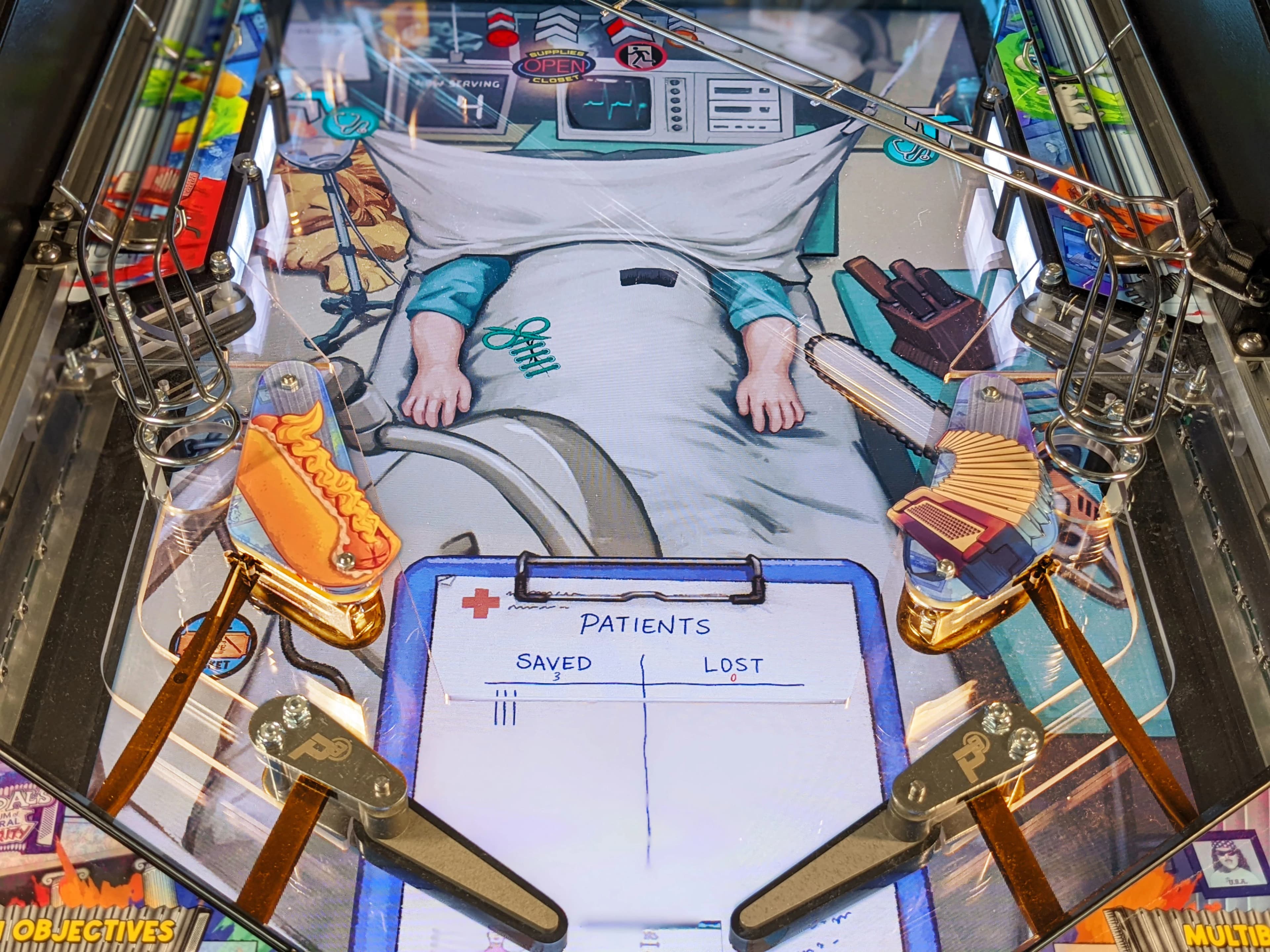 Hospital-themed pinball machine with patient score and medical equipment